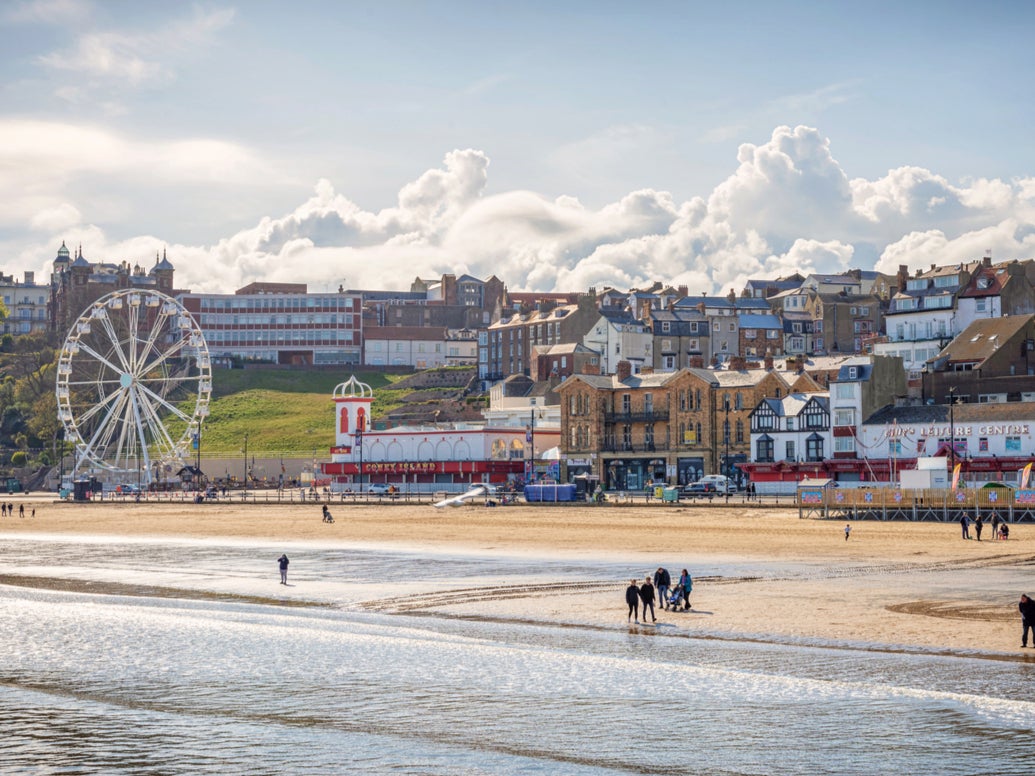 People enjoying the beach at Scarborough in the sunshine