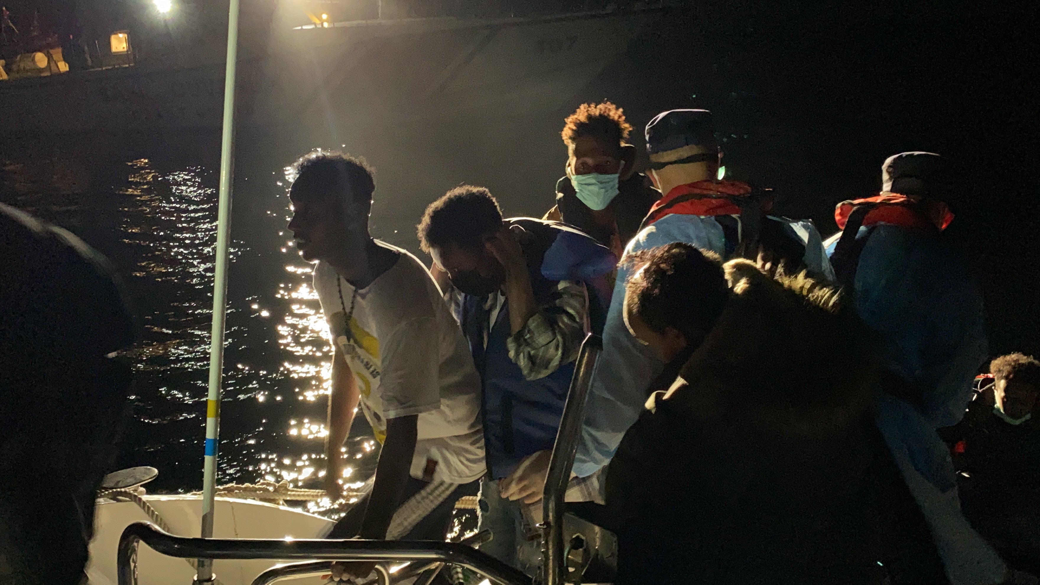 Stranded Somali migrants climb aboard a Turkish coastguard ship