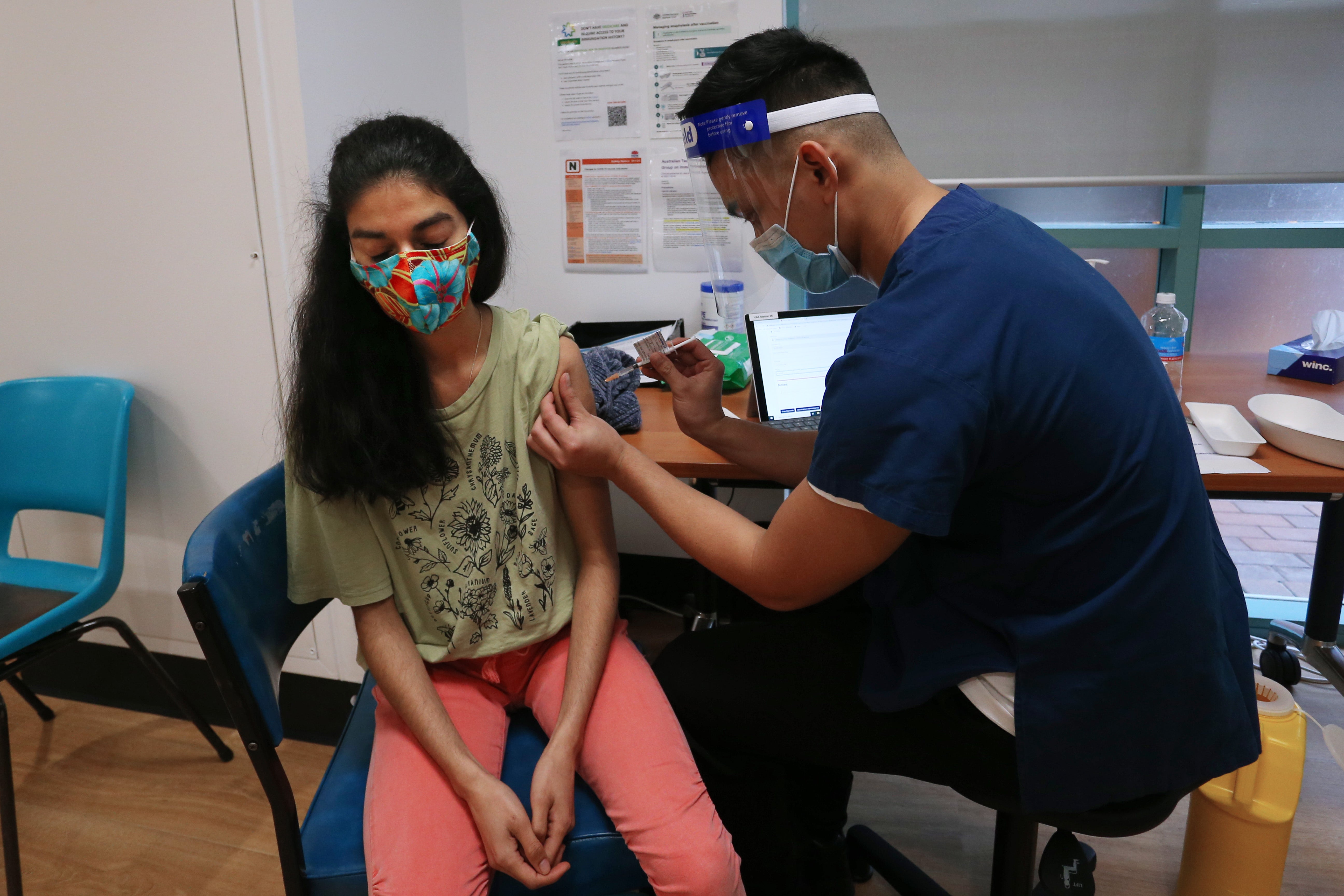 A nurse administers the Pfizer vaccine at a clinic in Sydney, Australia