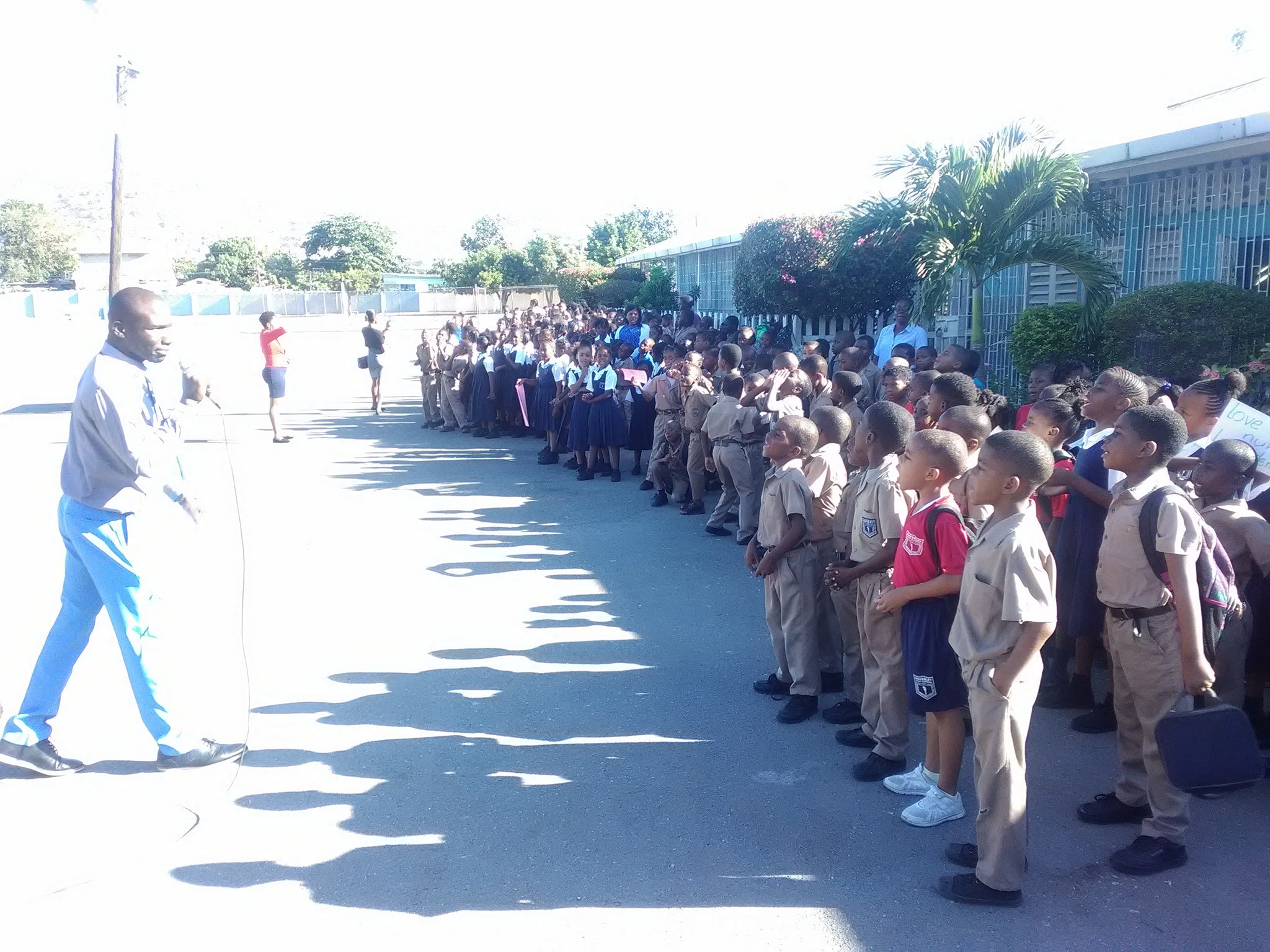 A teacher addressing students of the school