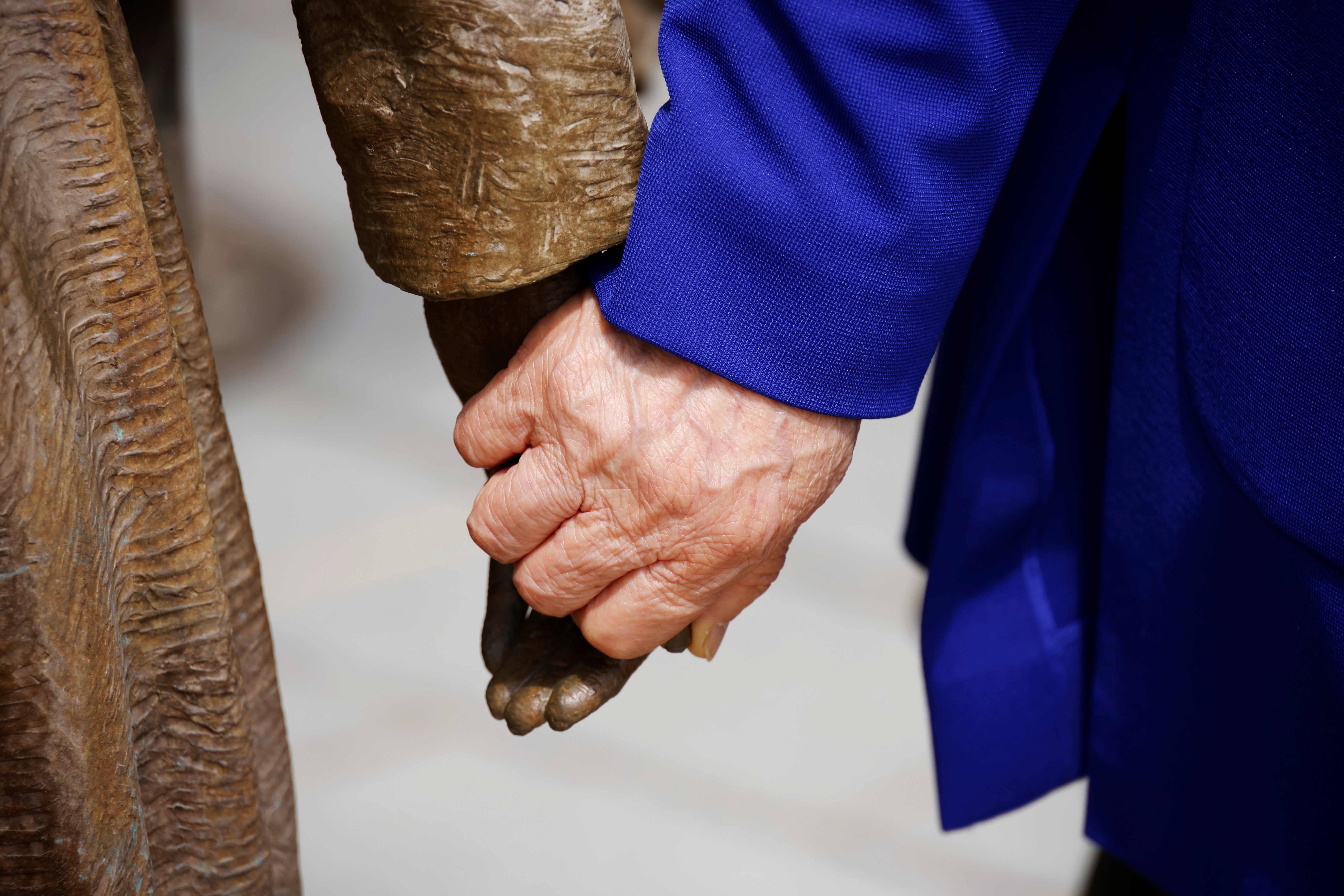 Former South Korean ‘comfort woman’ Lee Yong-soo holds the hand of a statue symbolising “comfort women” at the Seoul Comfort Women Memorial in Seoul, South Korea,