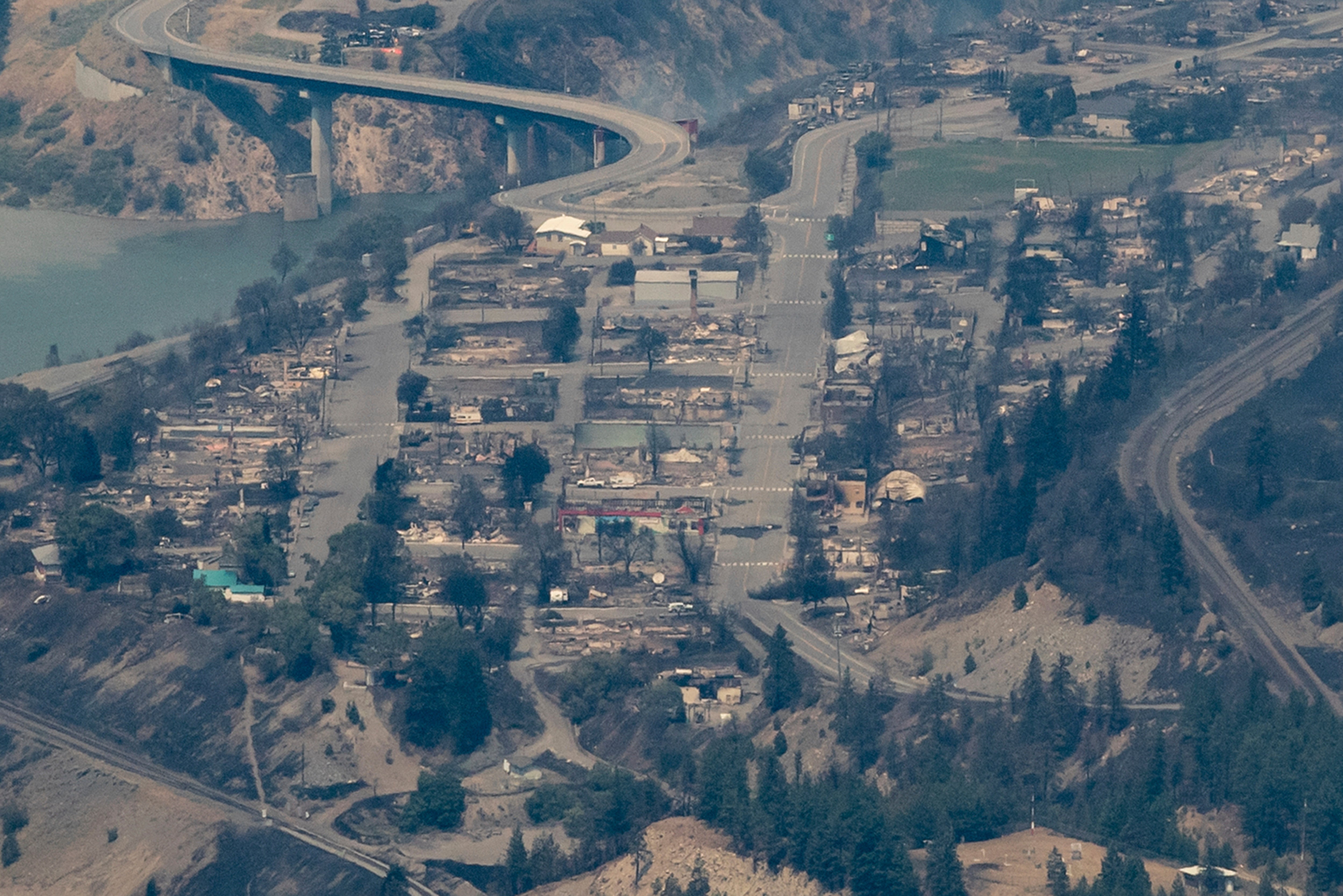 In this aerial photo taken from a helicopter, structures destroyed by a wildfire are seen in Lytton