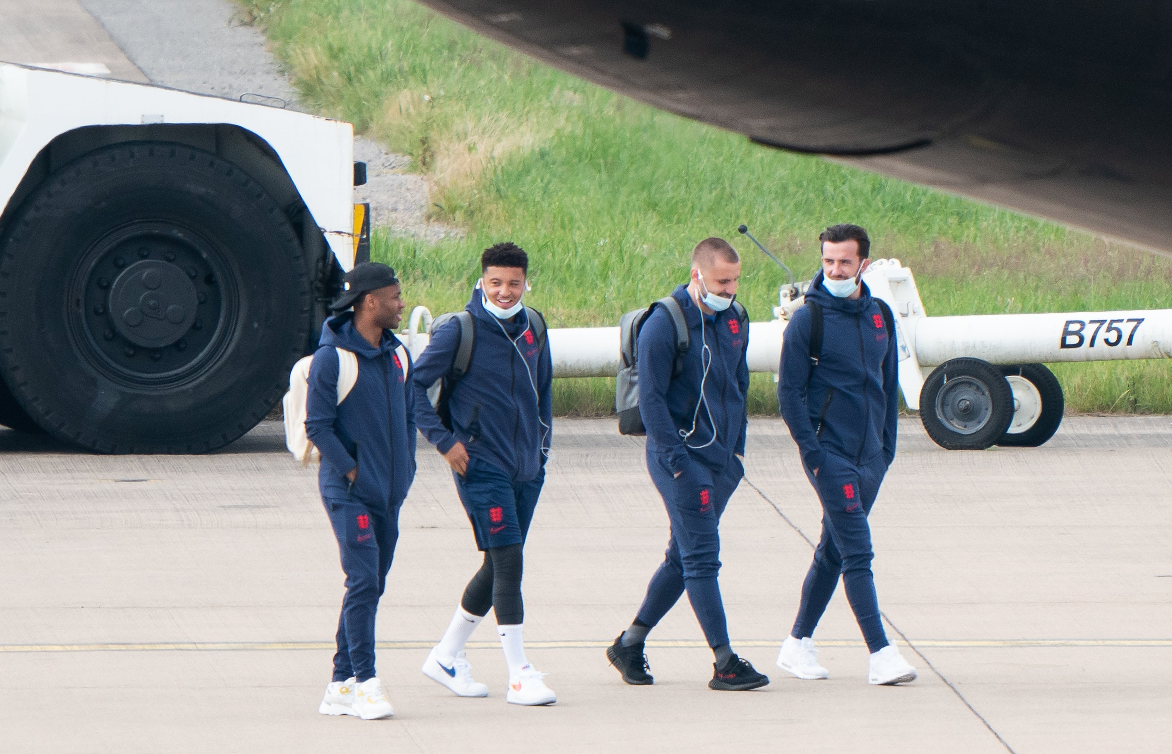 England’s Raheem Sterling, Jadon Sancho, Luke Shaw and Ben Chilwell on the tarmac heading to board the plane