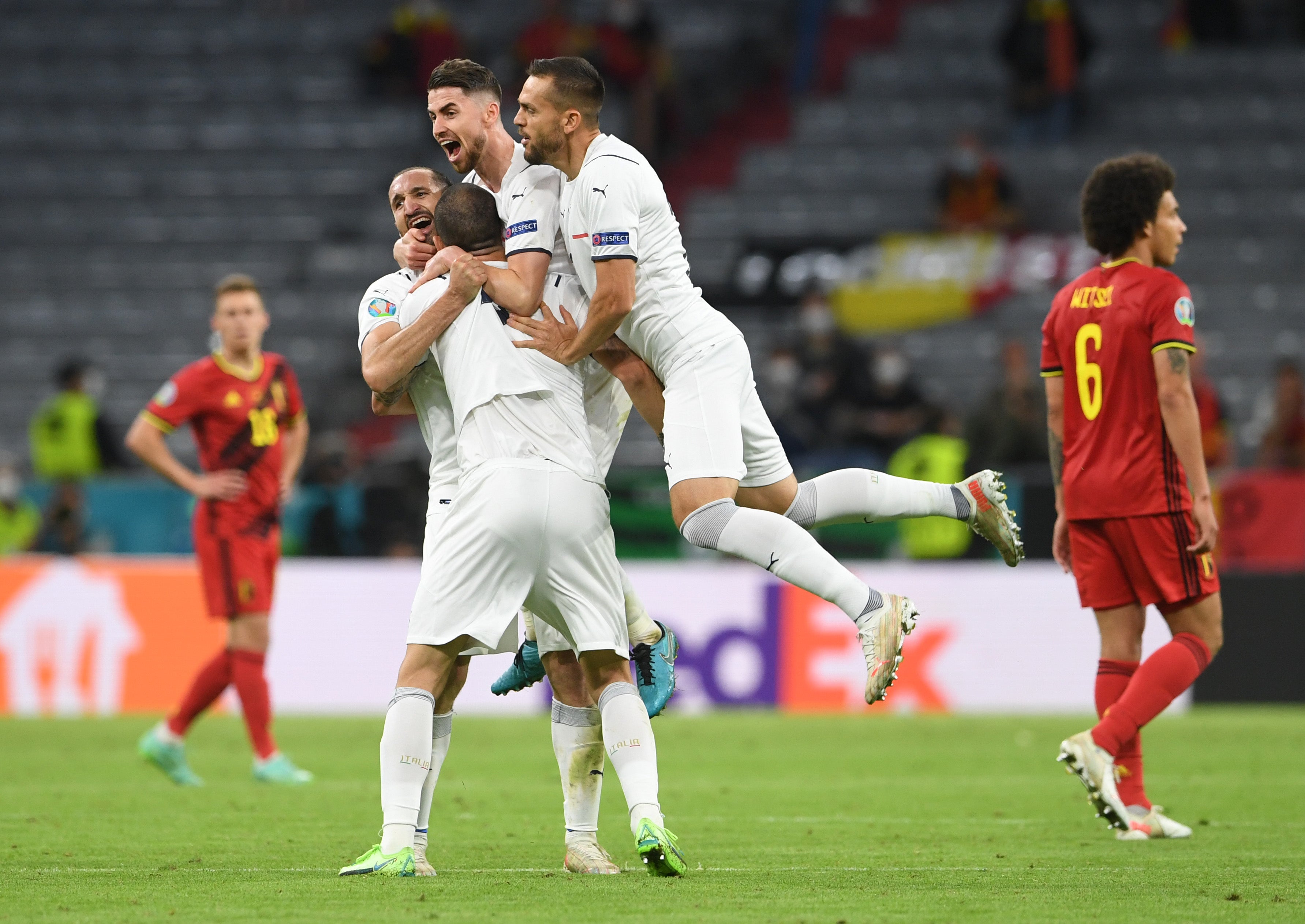 Italy celebrate as Thorgan Hazard and Axel Witsel look on