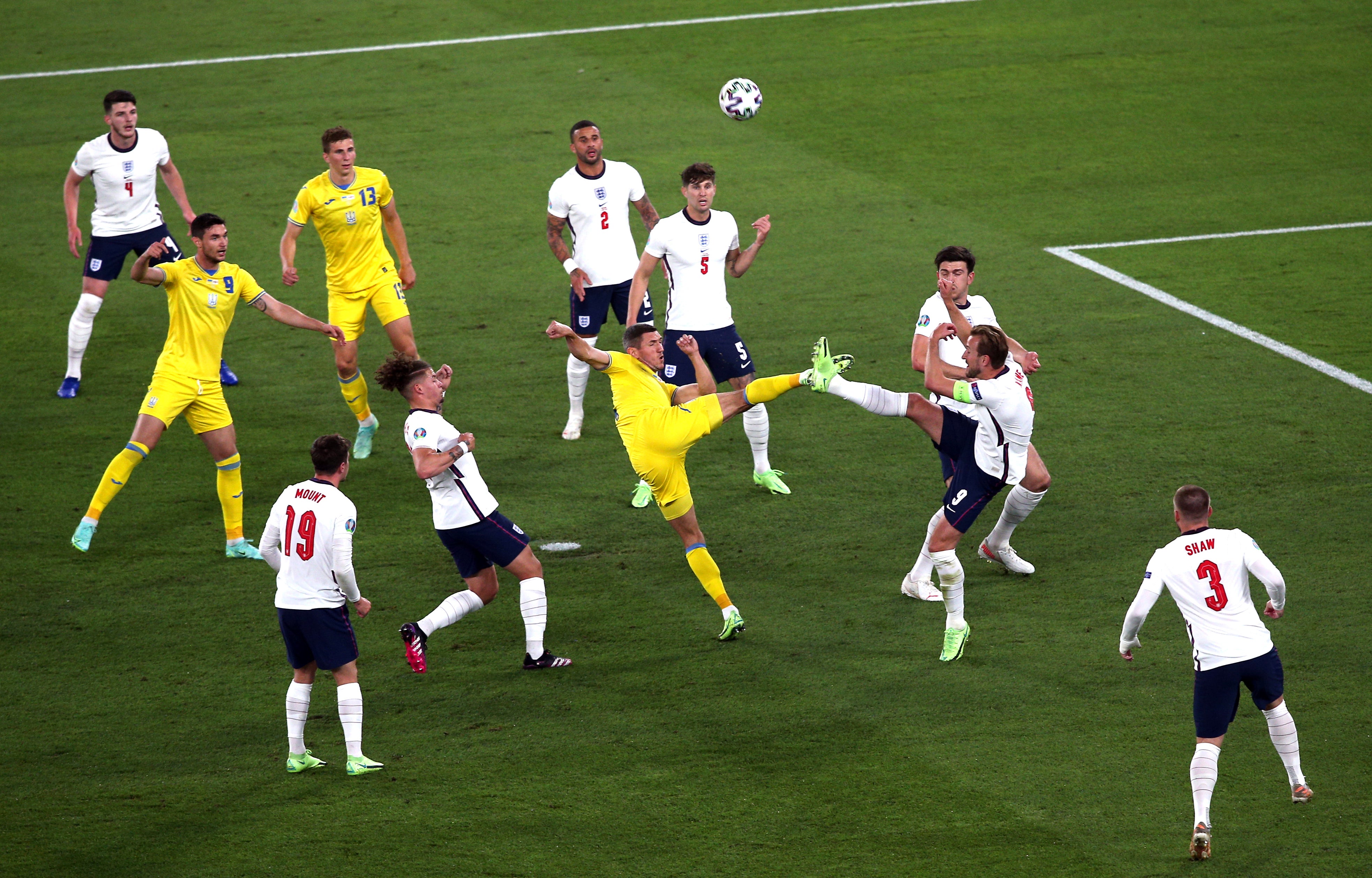 Harry Kane, right, prevents Sergey Krivtsov, centre, getting a shot away