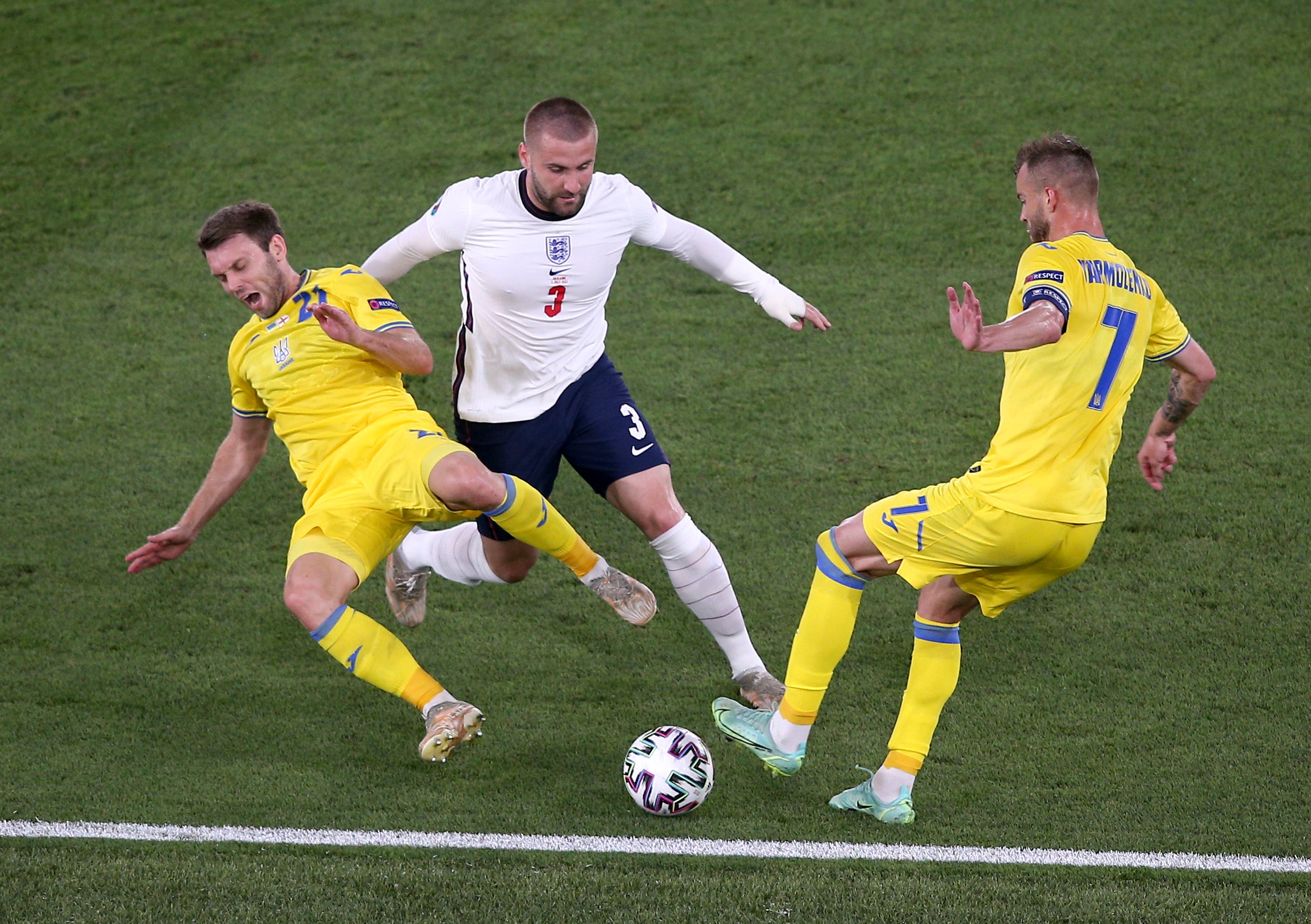 Luke Shaw, centre, battles for possession