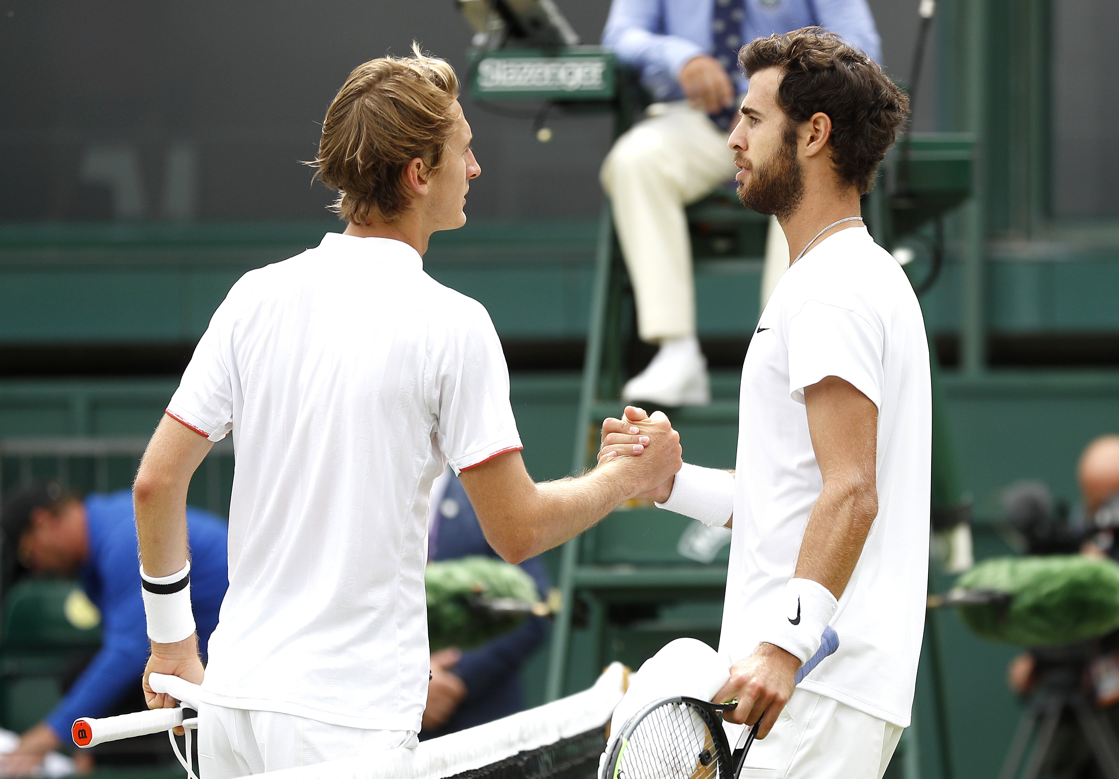 Karen Khanchanov (right) shakes hands with Sebastian Korda