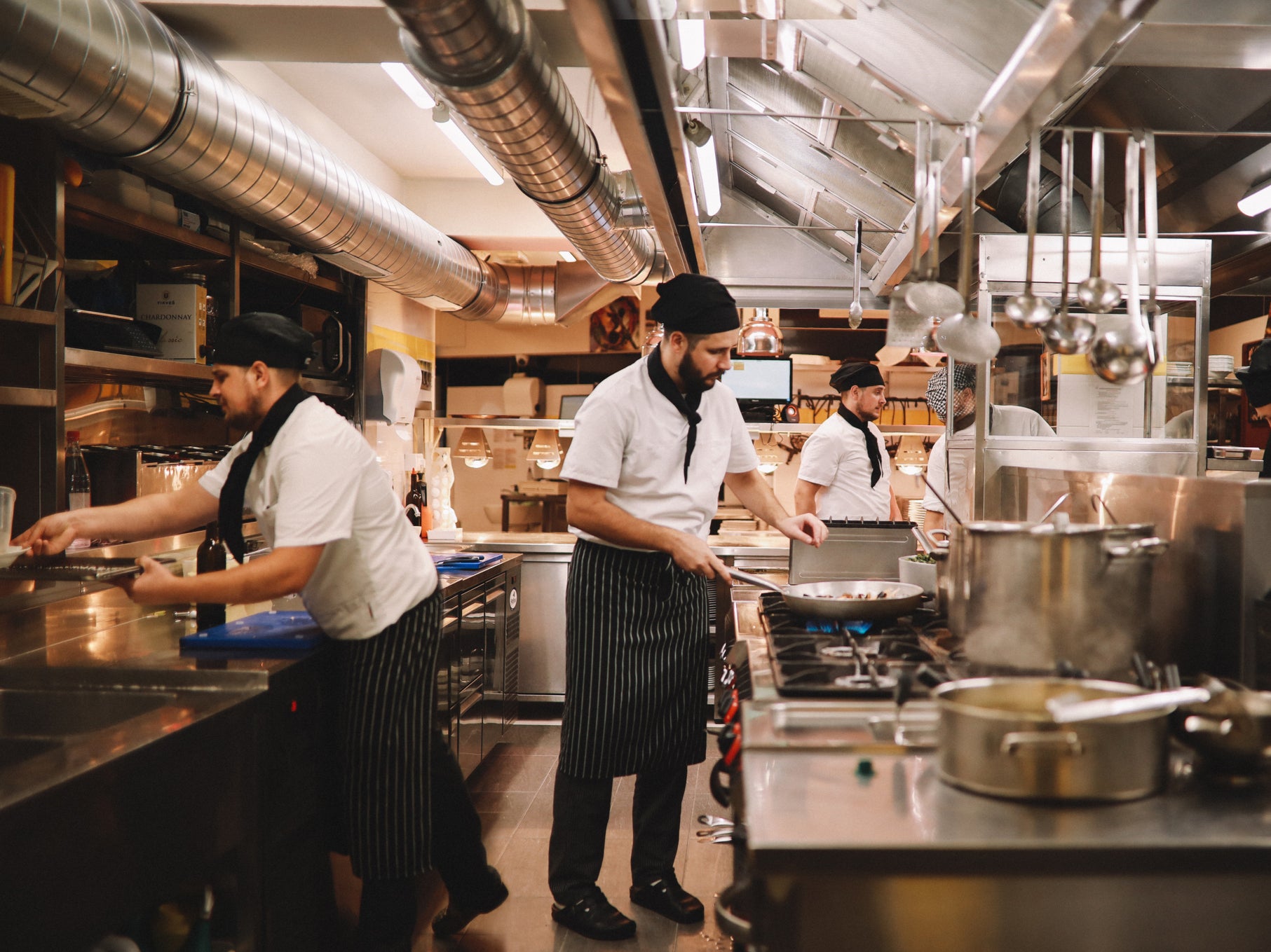 Restaurant kitchen crew preparing food