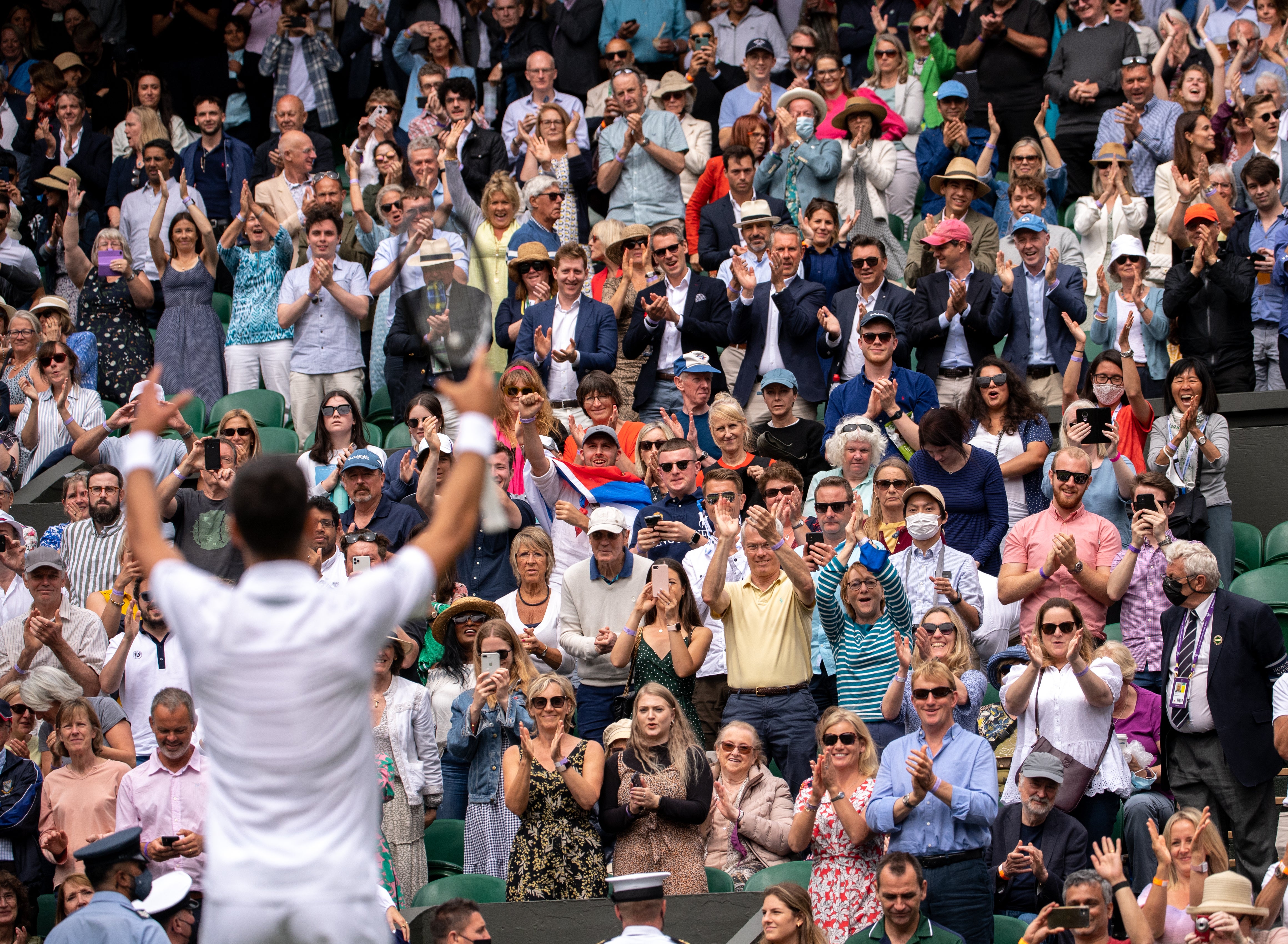 Novak Djokovic signals to the crowd after his victory