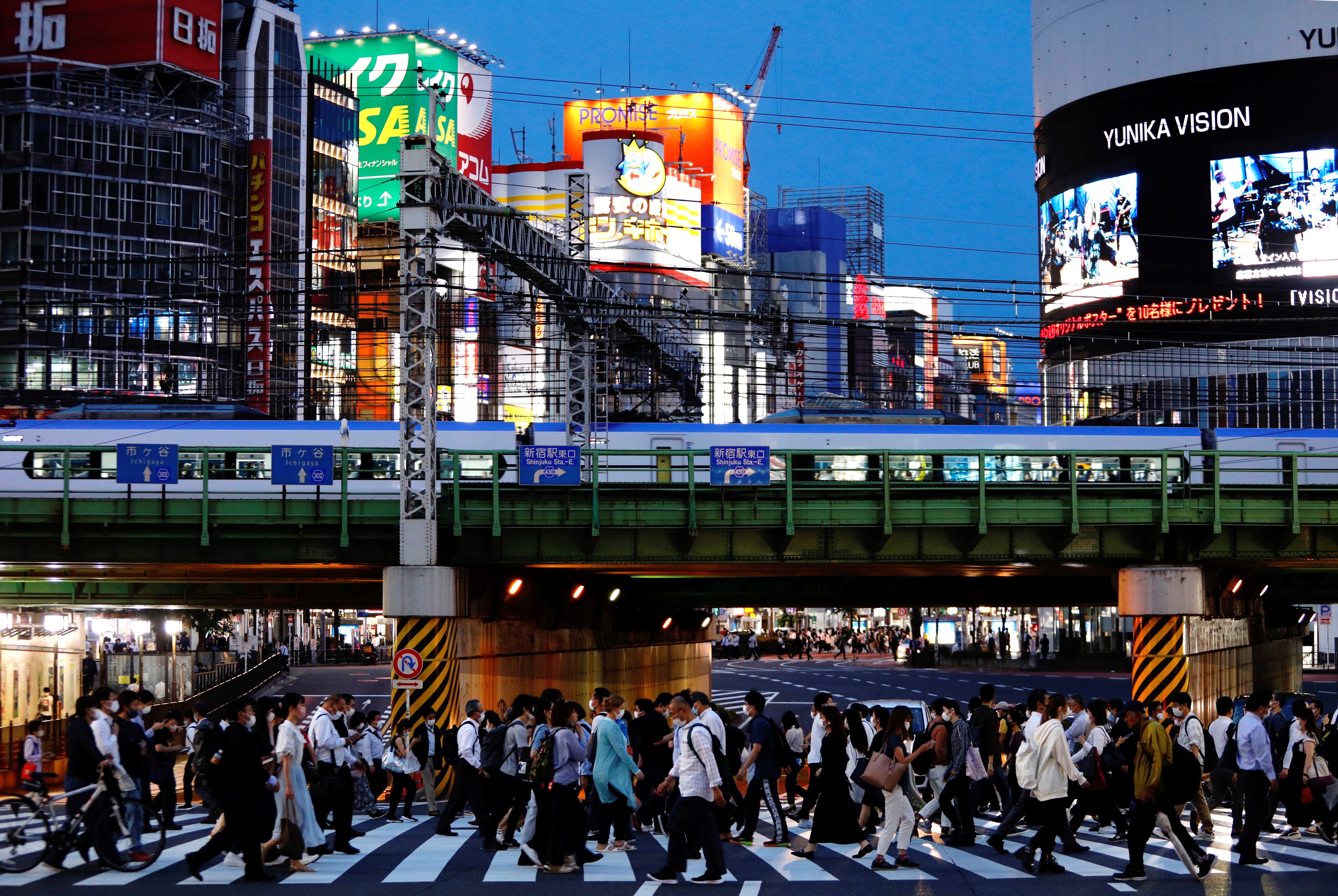 People cross a road in Shinjuku