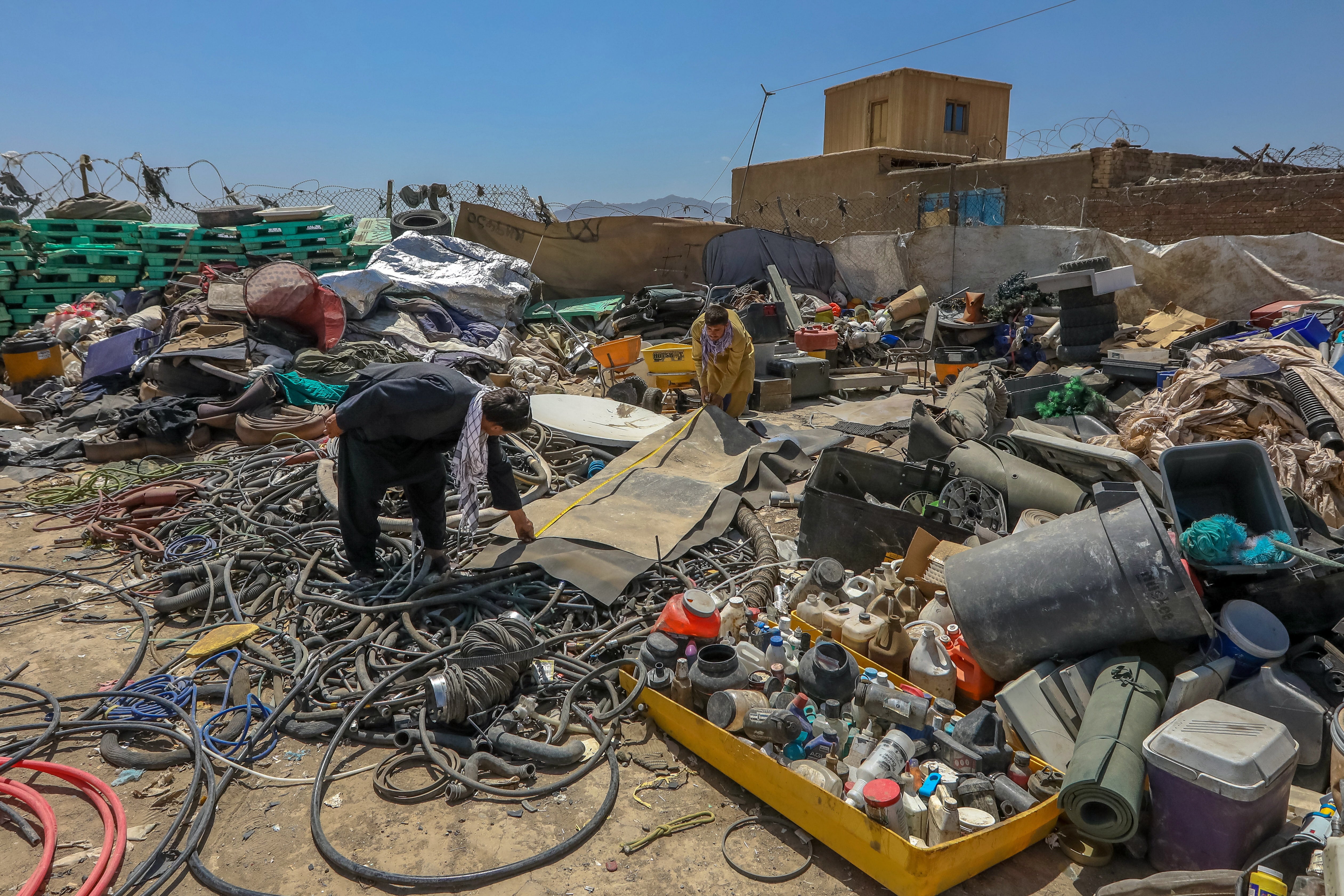 Afghan scrap dealers sort items which were discarded by the US forces outside Bagram Air Base, some 50 kilometers north of the capital Kabul, Afghanistan, 03 July 2021.