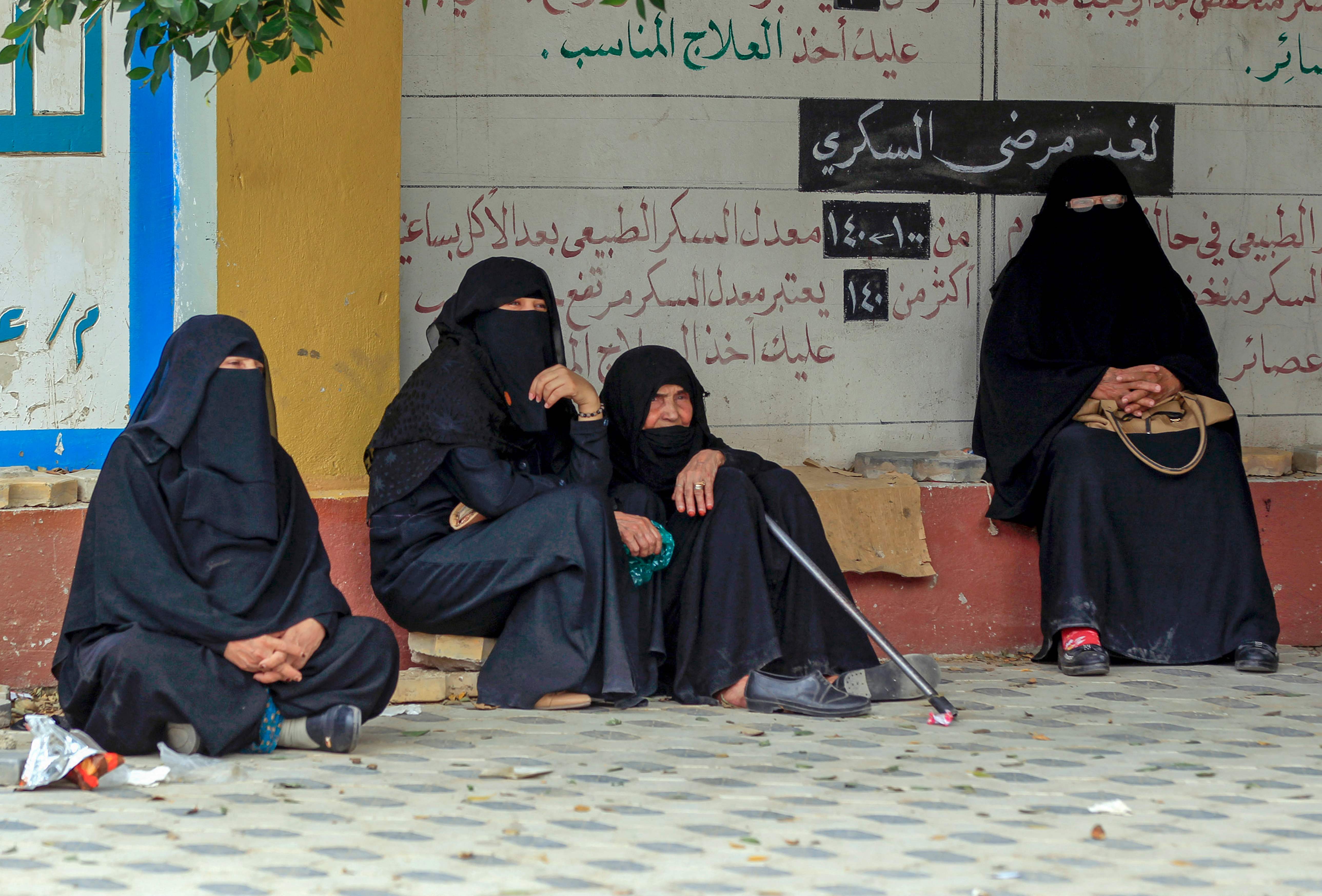 Yemeni women wait outside a medical center to be seen by doctors in the capital Sanaa