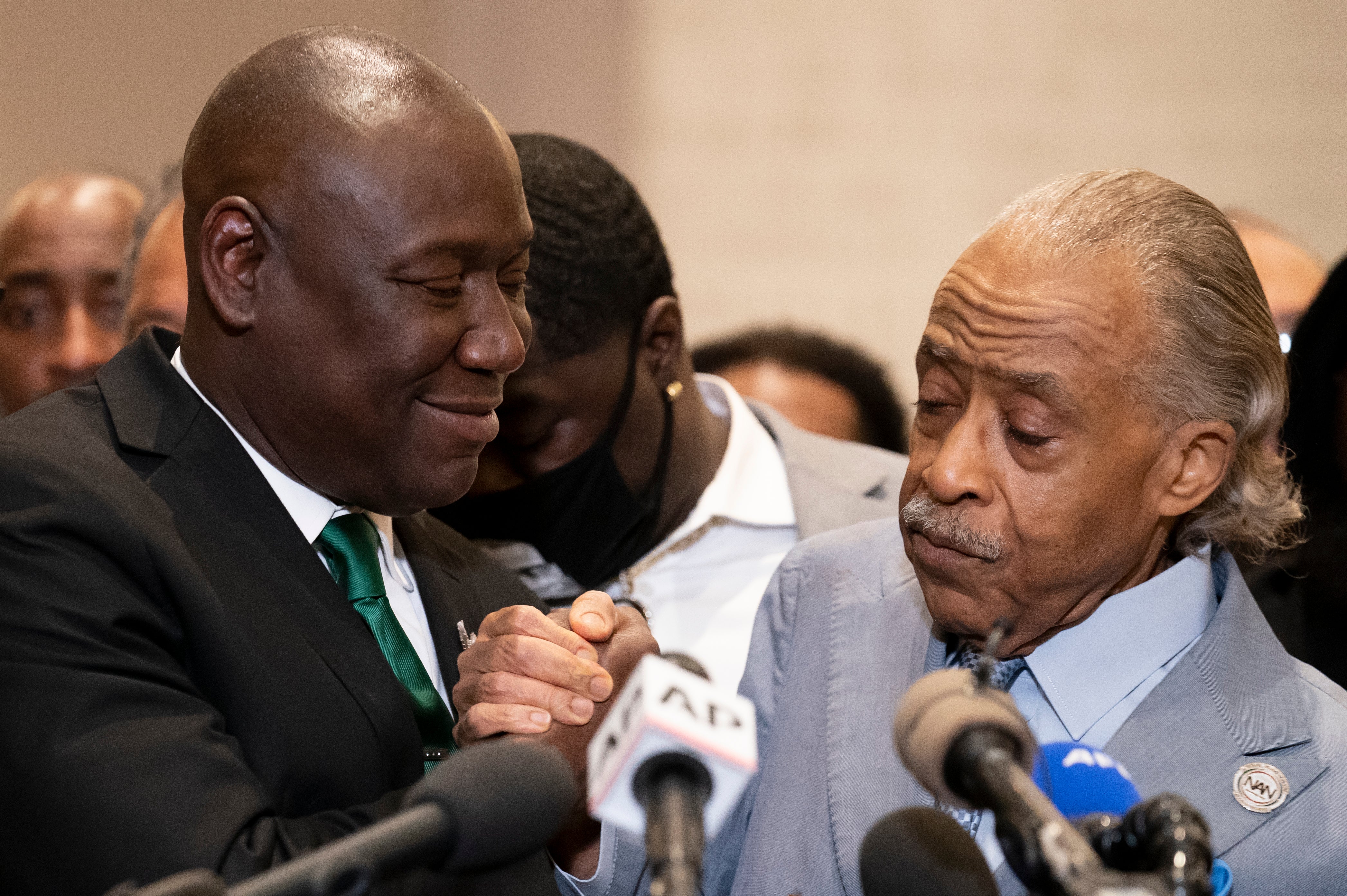 Mr Crump, left, with Reverand Al Sharpton at a news conference after former Minneapolis police Officer Derek Chauvin was convicted in the George Floyd killing