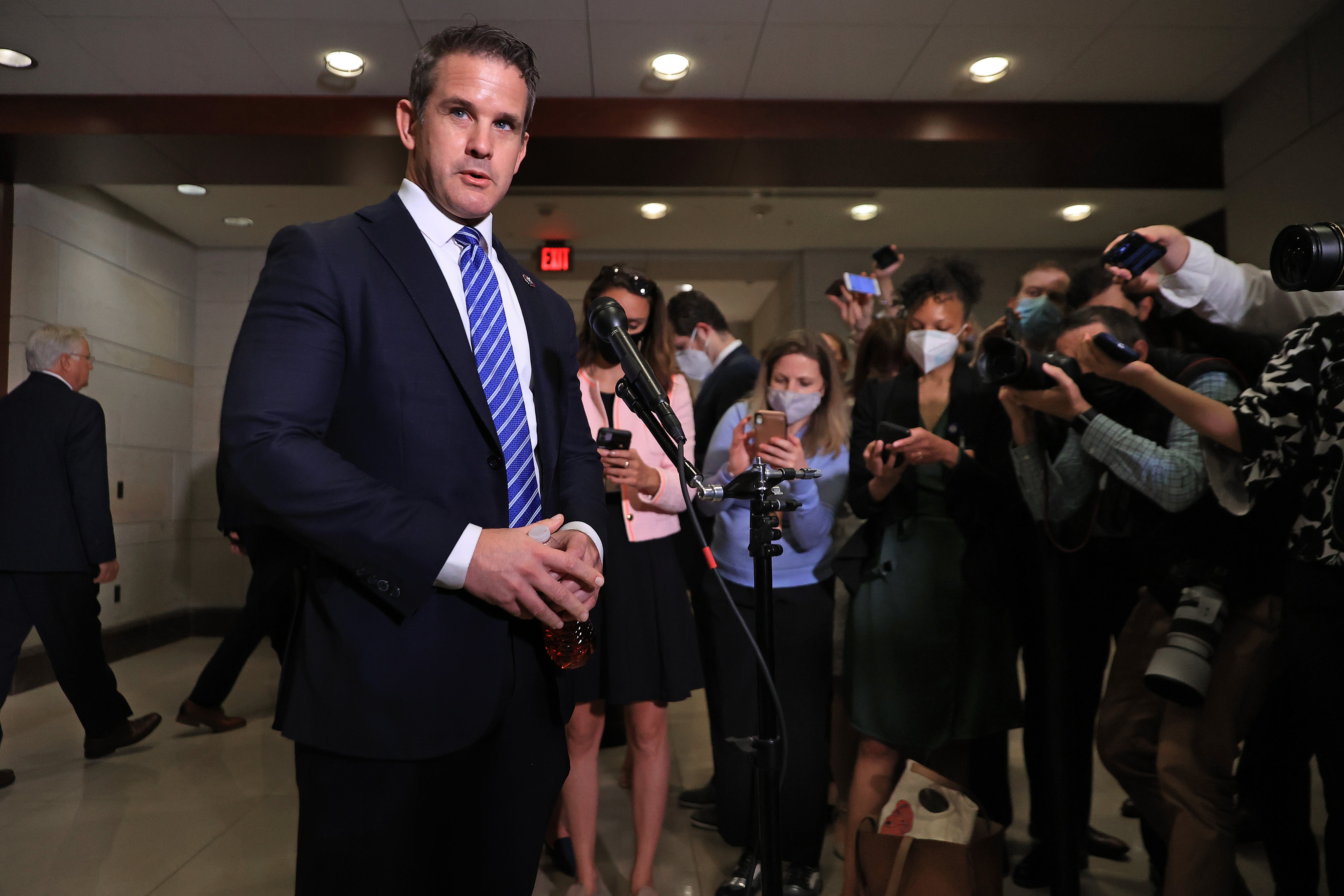 Congressman Adam Kinzinger talks to reporters in the Capitol.