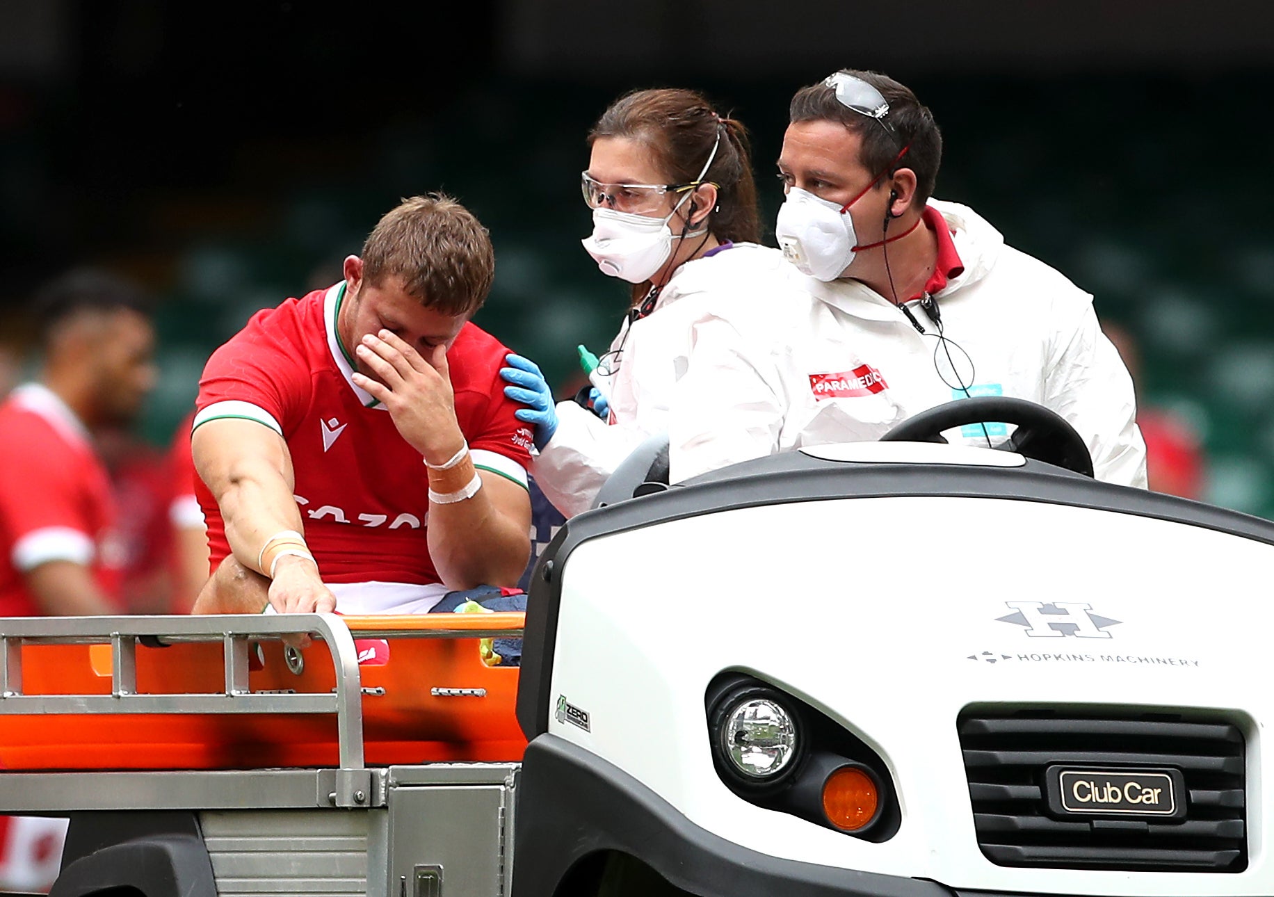 Leigh Halfpenny, left, leaves the pitch on a medical cart against Canada