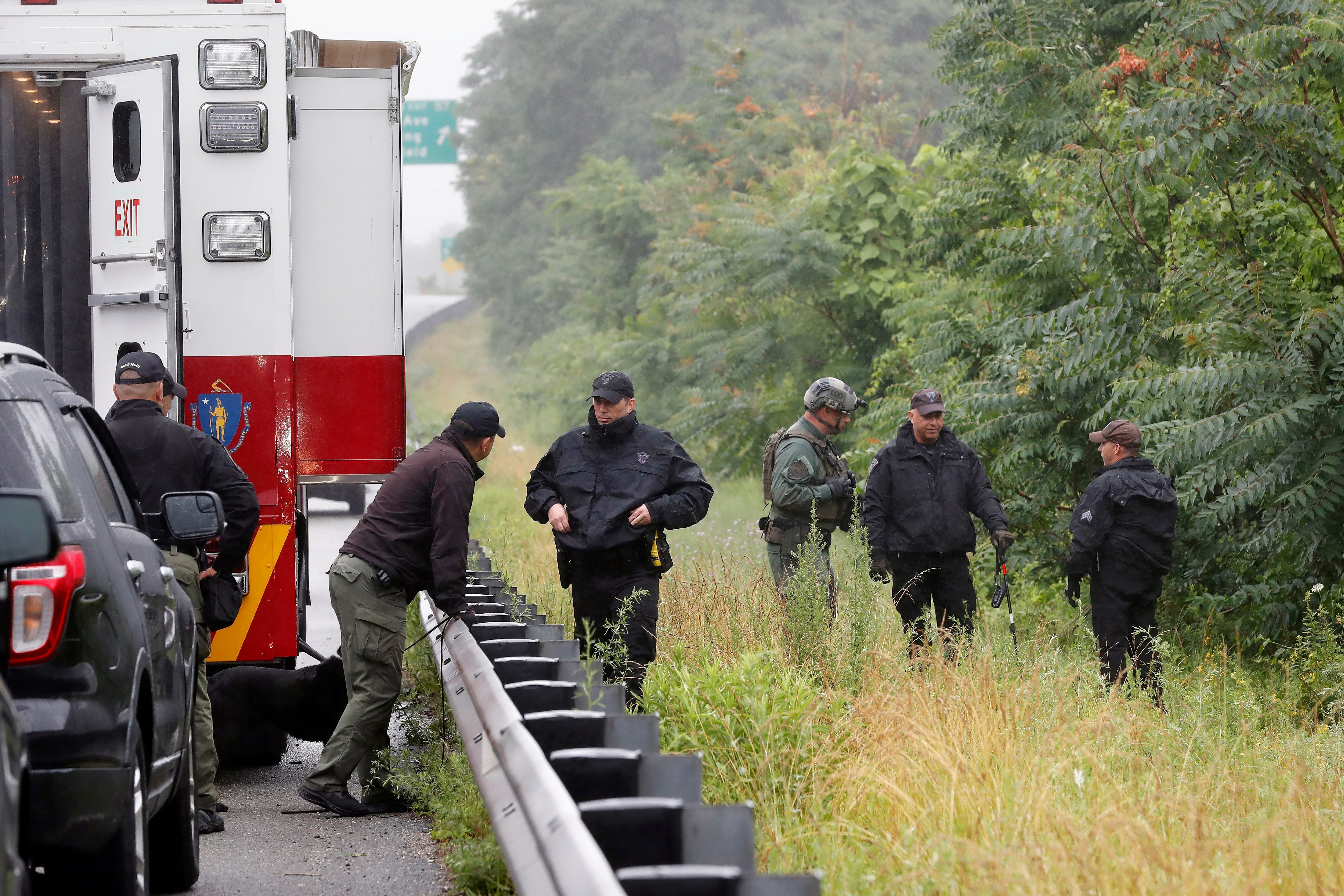 Police work in the area of an hours long standoff with a group of armed men that partially shut down interstate 95, Saturday, July 3, 2021, in Wakefield, Massachusetts