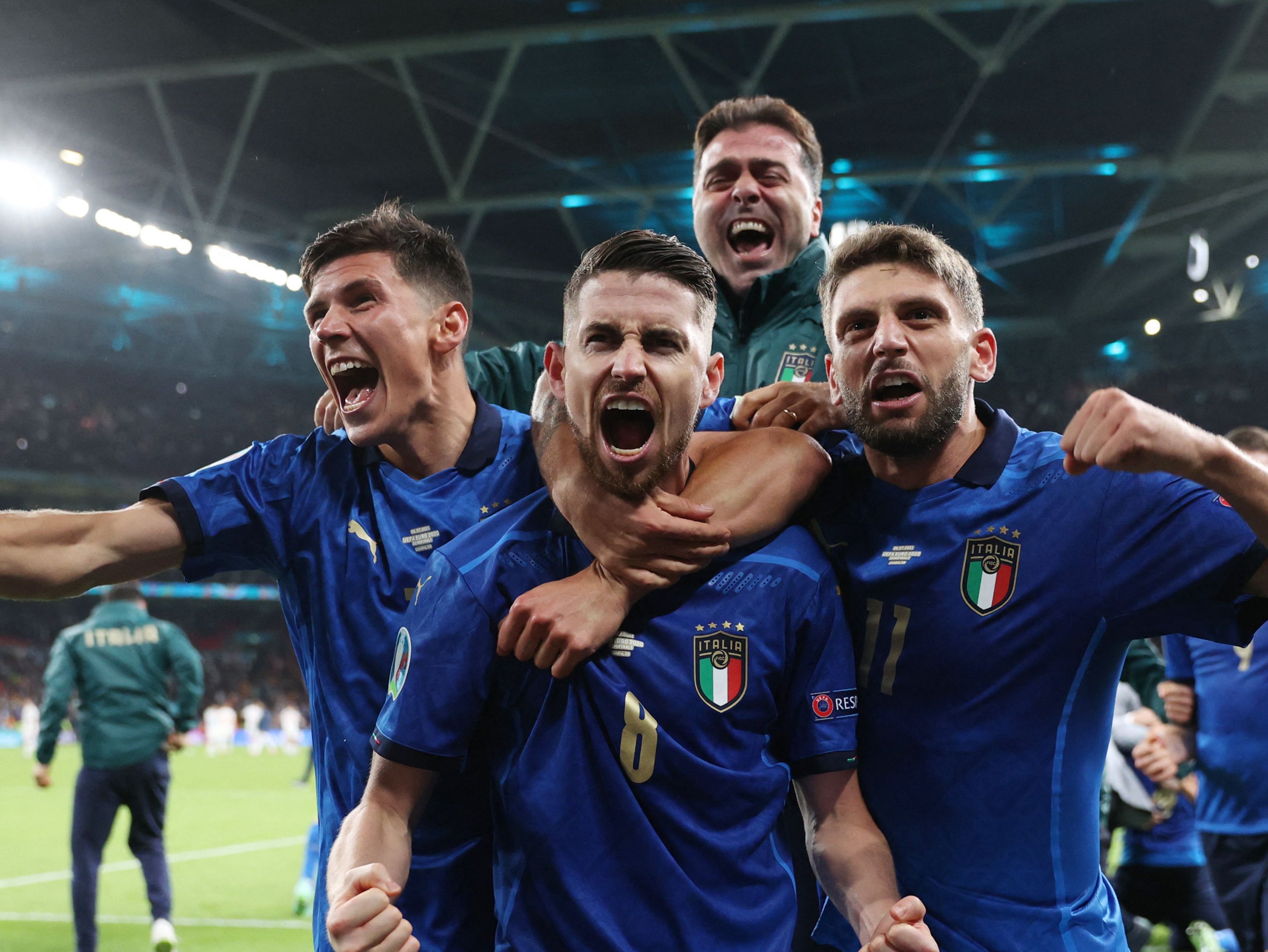 Jorginho celebrates with teammates after scoring in a penalty shootout