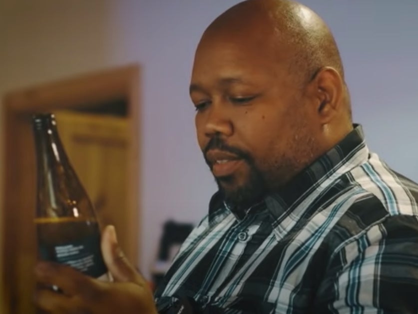 A screenshot from the ad by the Polish brewery showing a Black bar man having a beer called ‘White IPA Matters’ surrounded by symbols from the US’s deep south