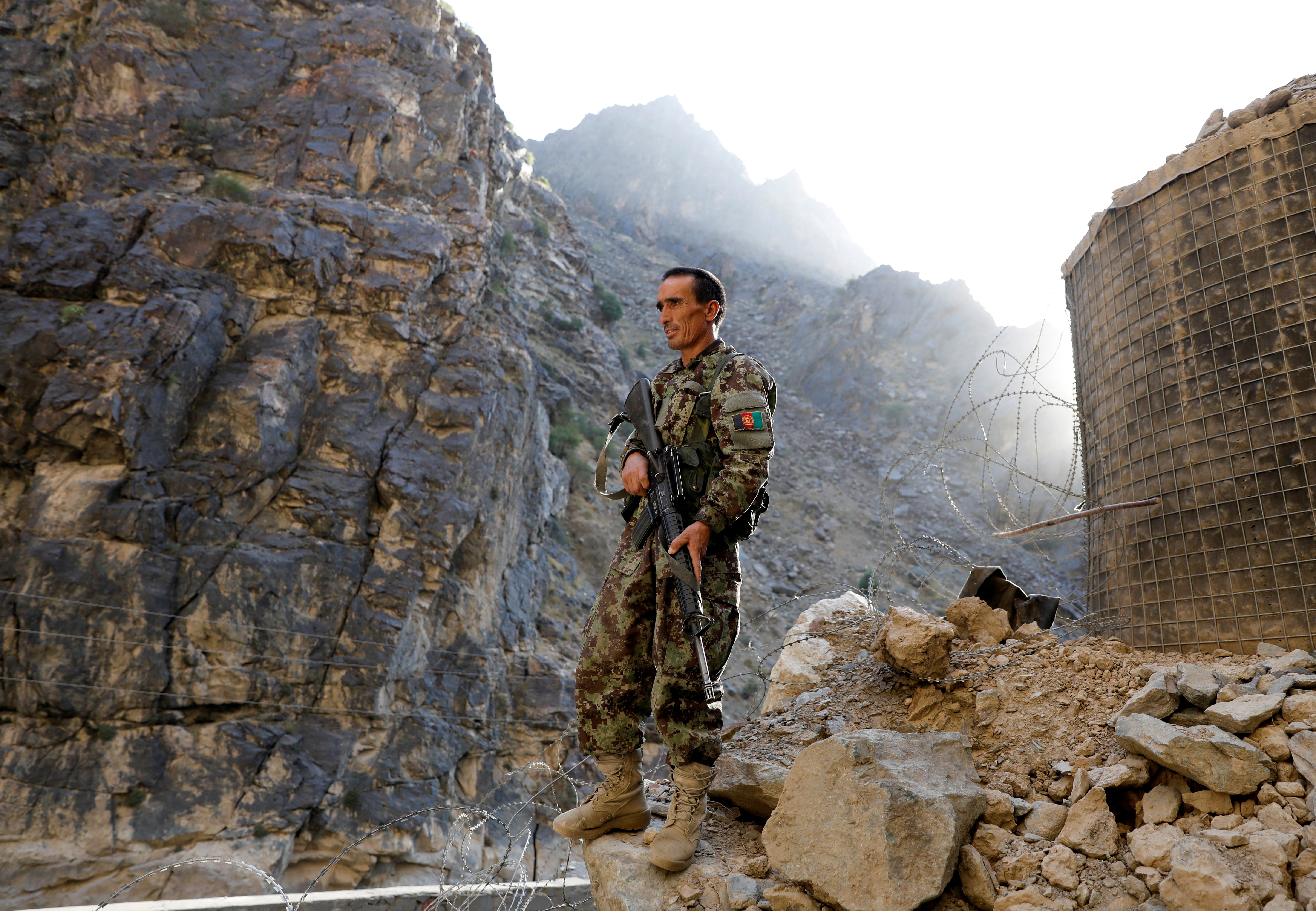 An Afghan National Army soldier stands guard at the check post at Mahipar, on Jalalabad-Kabul highway