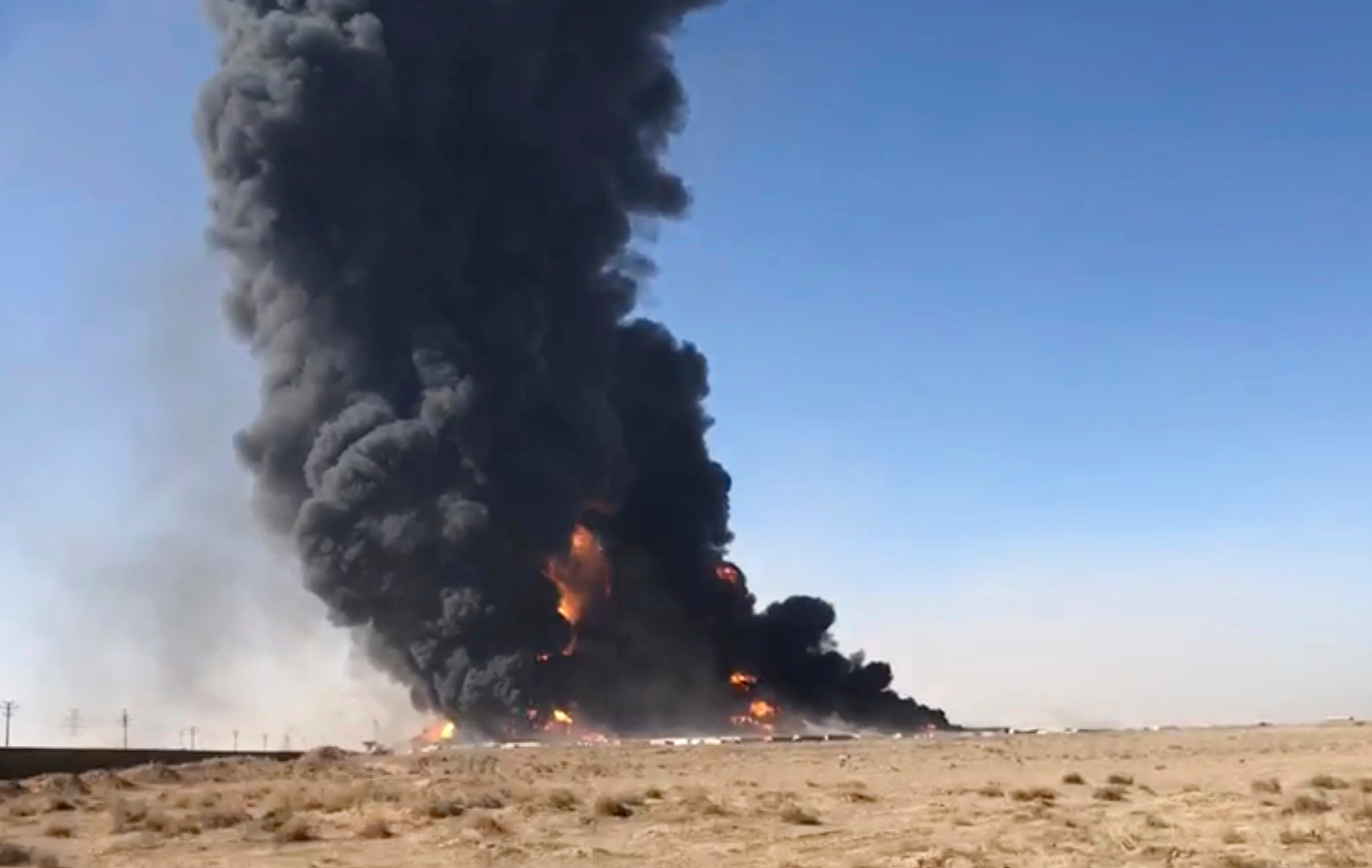 Smoke rises from fuel tankers at the Islam Qala border with Iran, in Herat Province, west of Kabul, Afghanistan. Taliban have taken control of Islam Qala crossing border in western Herat province