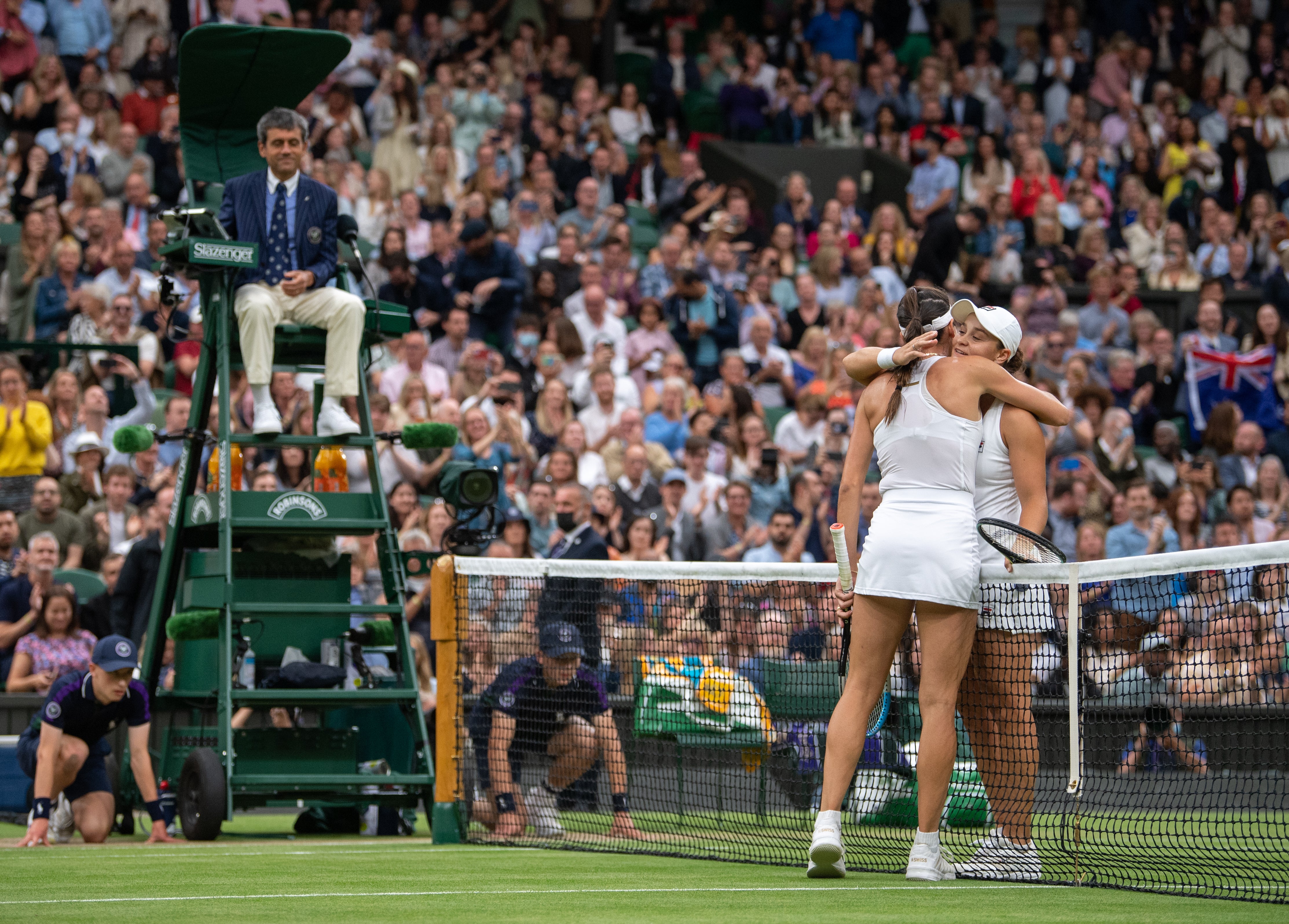 Ashleigh Barty (right) hugs Ajla Tomljanovic on Centre Court