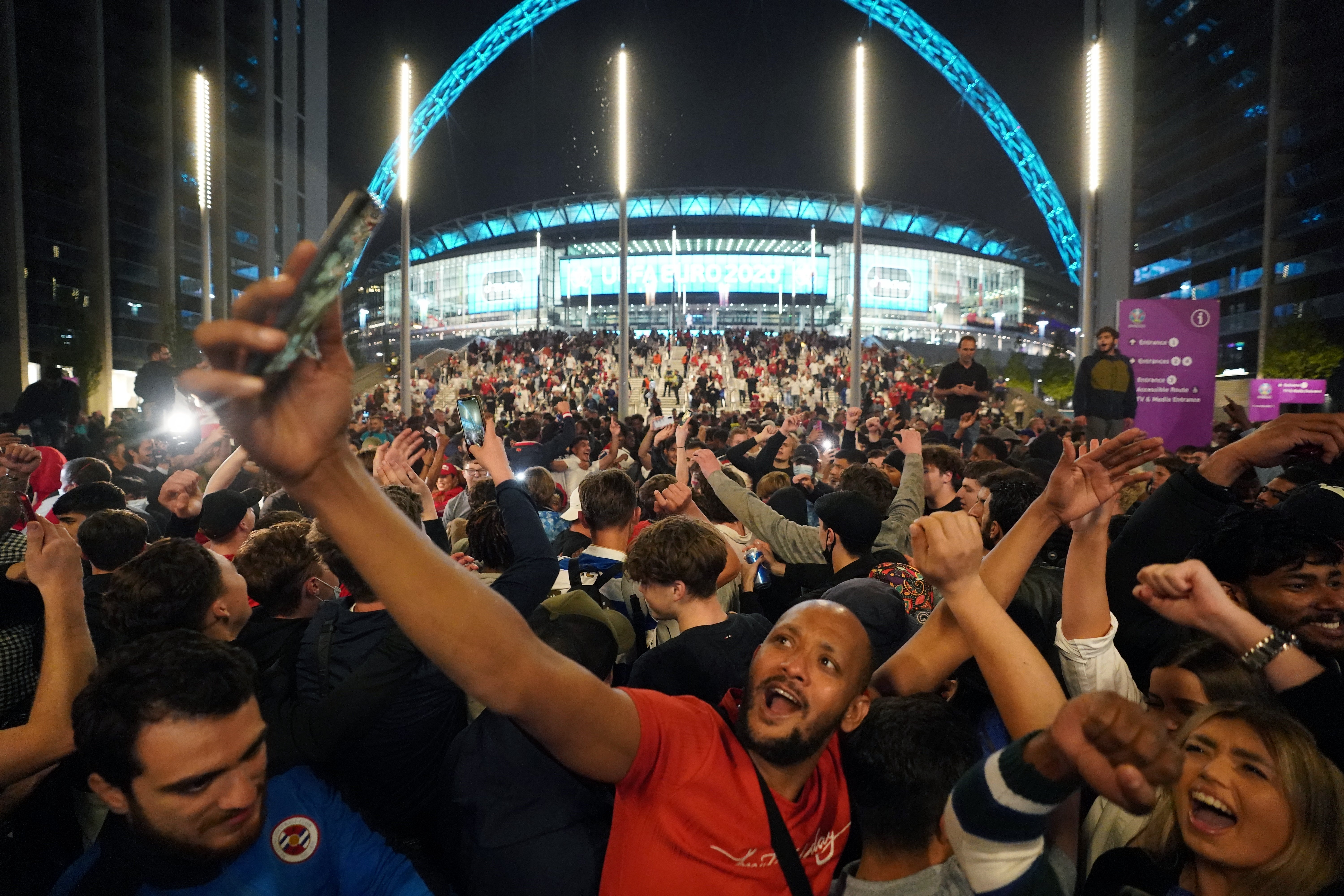 Fans celebrate outside Wembley Stadium after England qualified for the Euro 2020 final