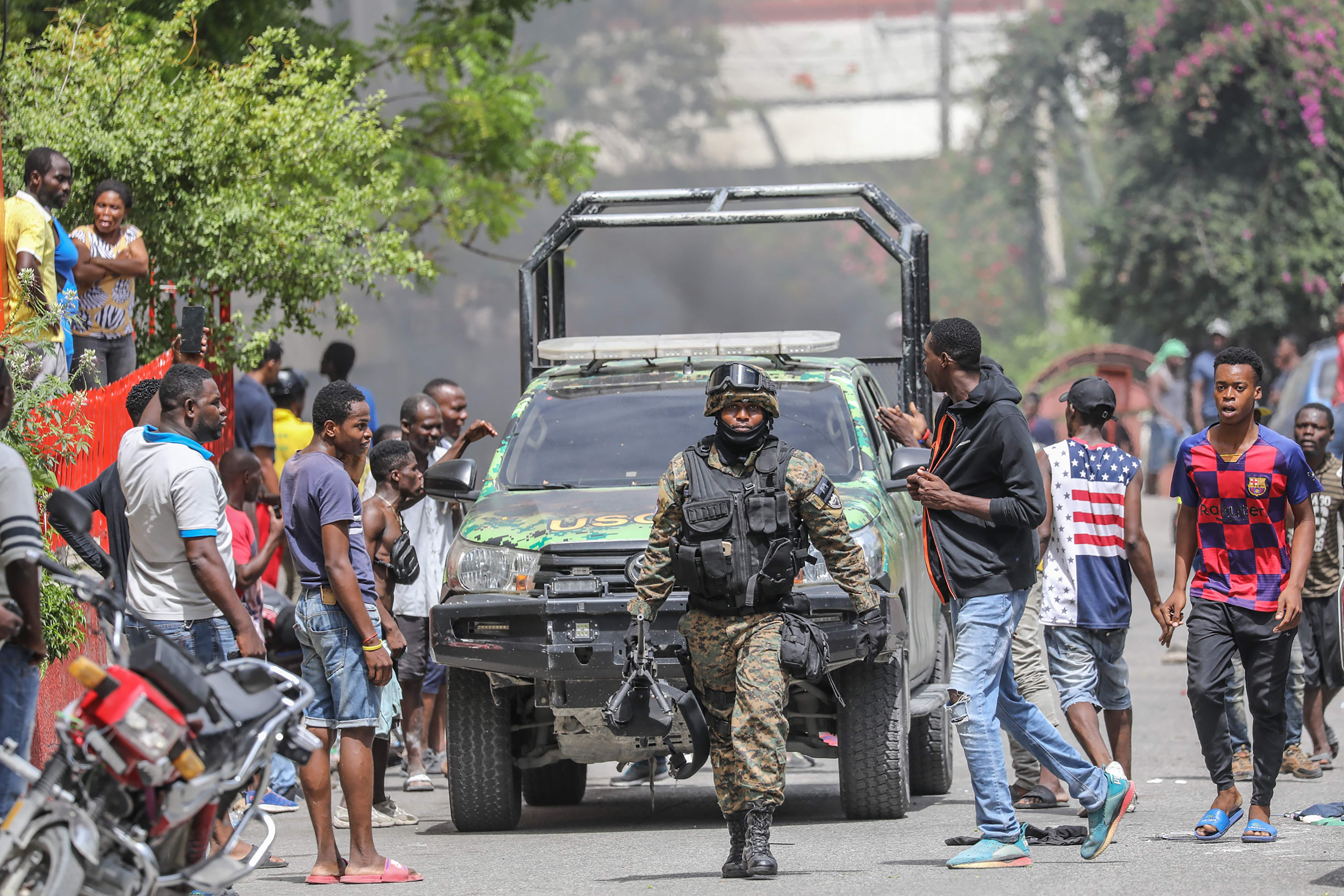 People surround police station holding suspect in assassination