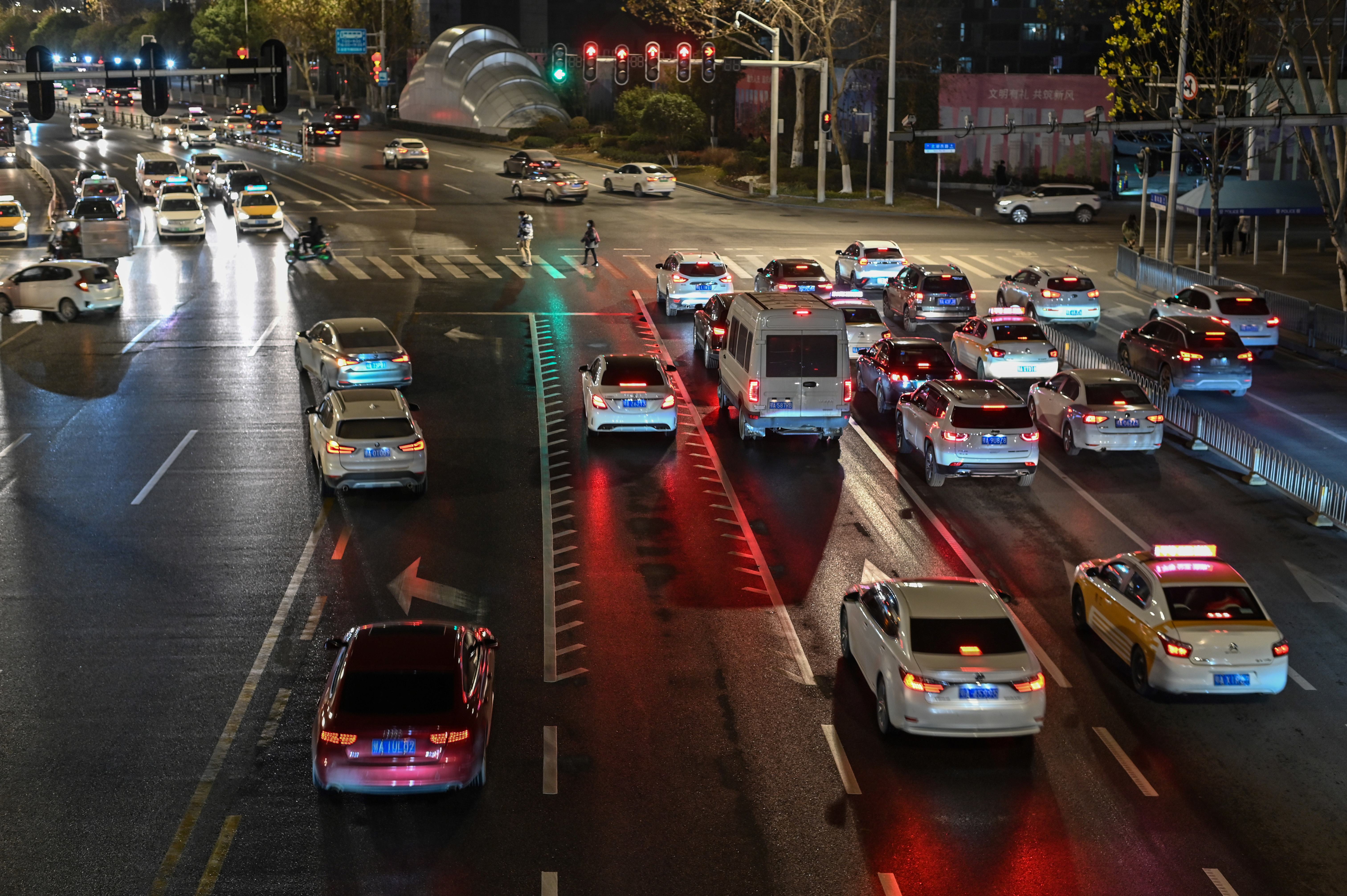 File: This photo, taken on 19 January 2021, shows a general view of traffic at a red light on a street in Wuhan, China