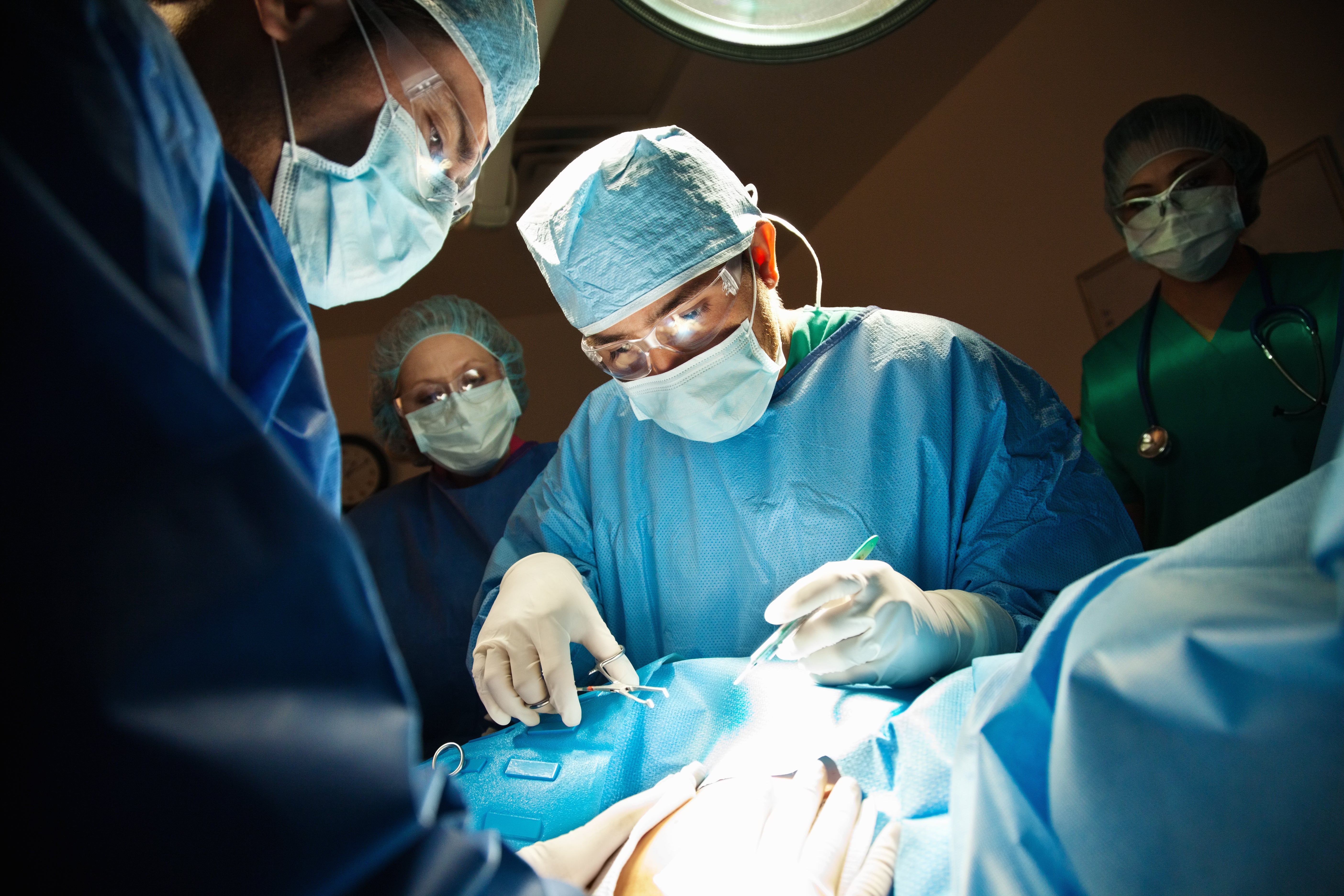 Surgeons performing C-Section in operating room