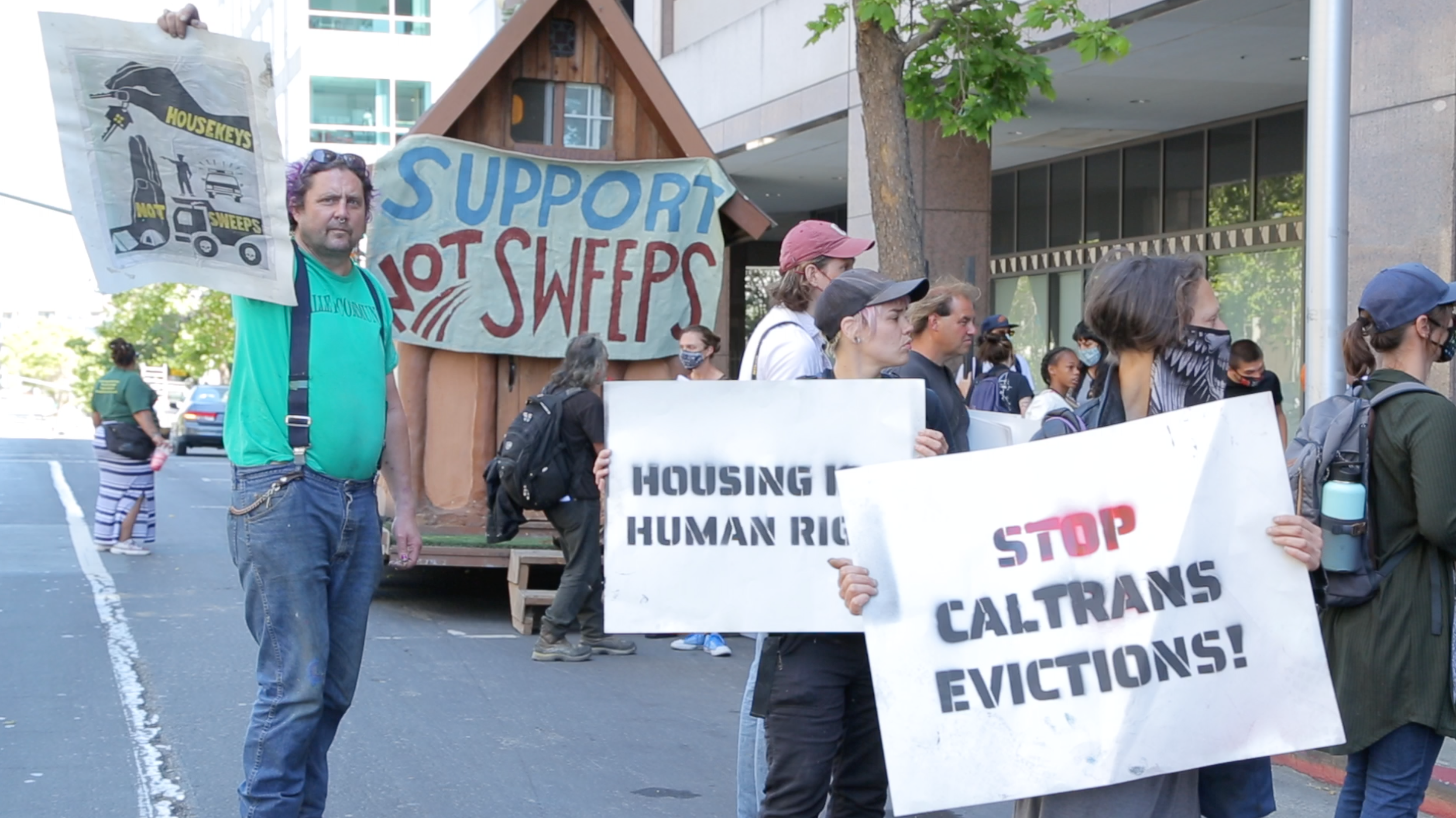 Protesters gather outside of Caltrans’s regional office in Oakland in June, 2021, to protest the potential evictions at the Wood Street homeless encampment.