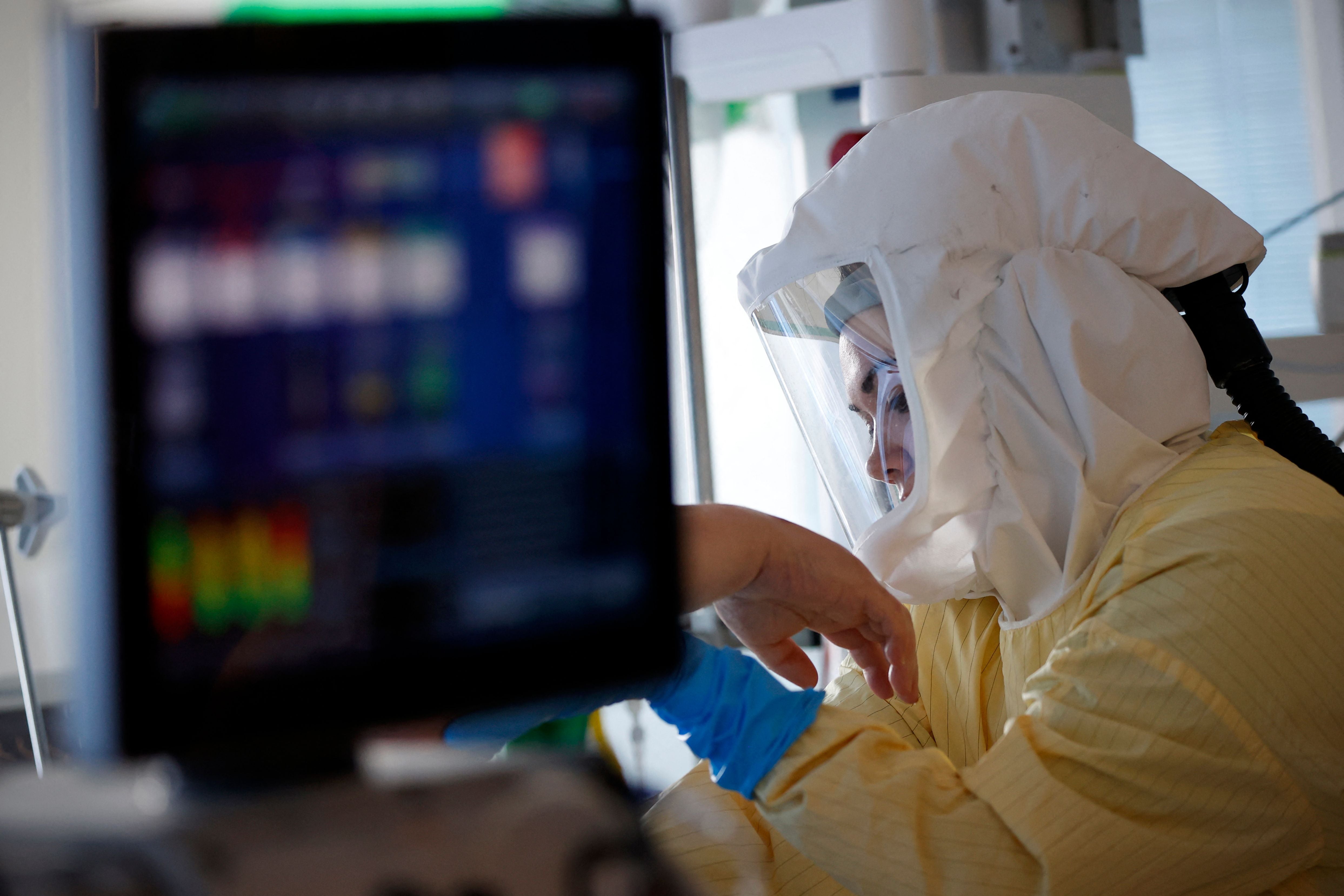 A critical care nurse tends to a Covid-19 patient in an intensive care unit