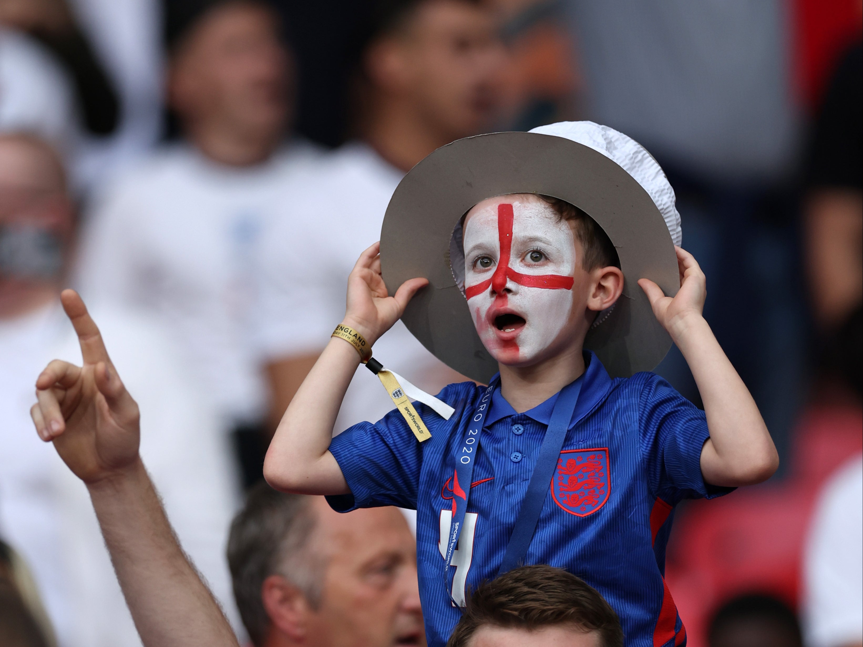 A young England fan wears face paint to show his support