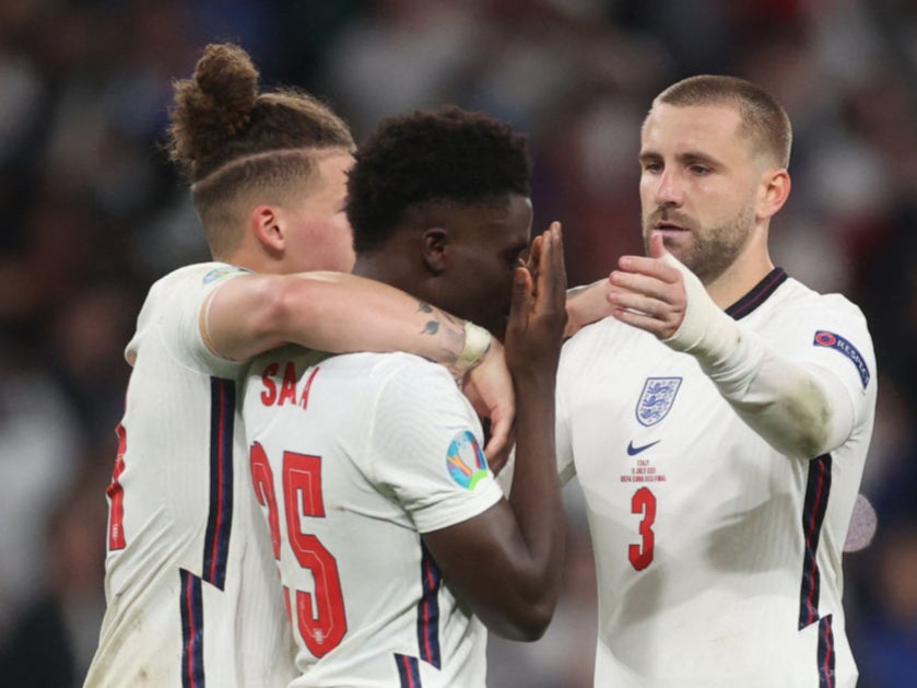 Kalvin Phillips (left) and Luke Shaw console Bukayo Saka after the Arsenal teenager missed the decisive spot kick