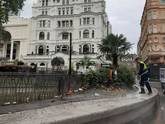 A worker cleans up Leicester Square on Monday morning