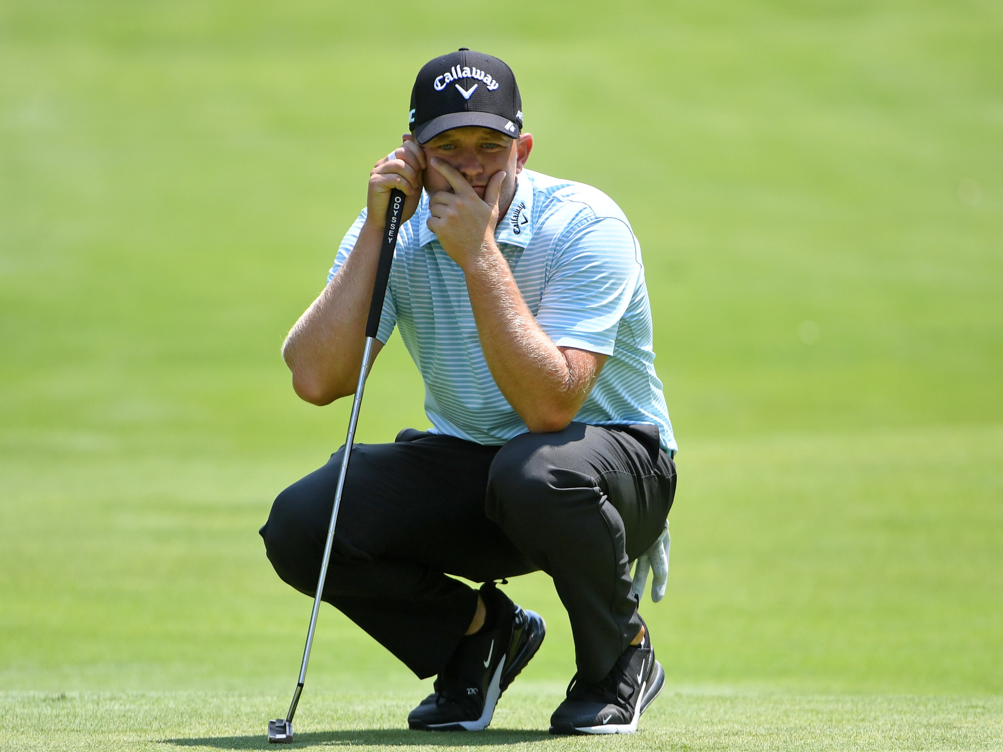 Tom Lewis lines up a putt during the Rocket Mortgage Classic in July