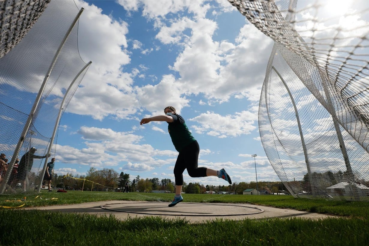 Bickford throws the discus and sets a new school record