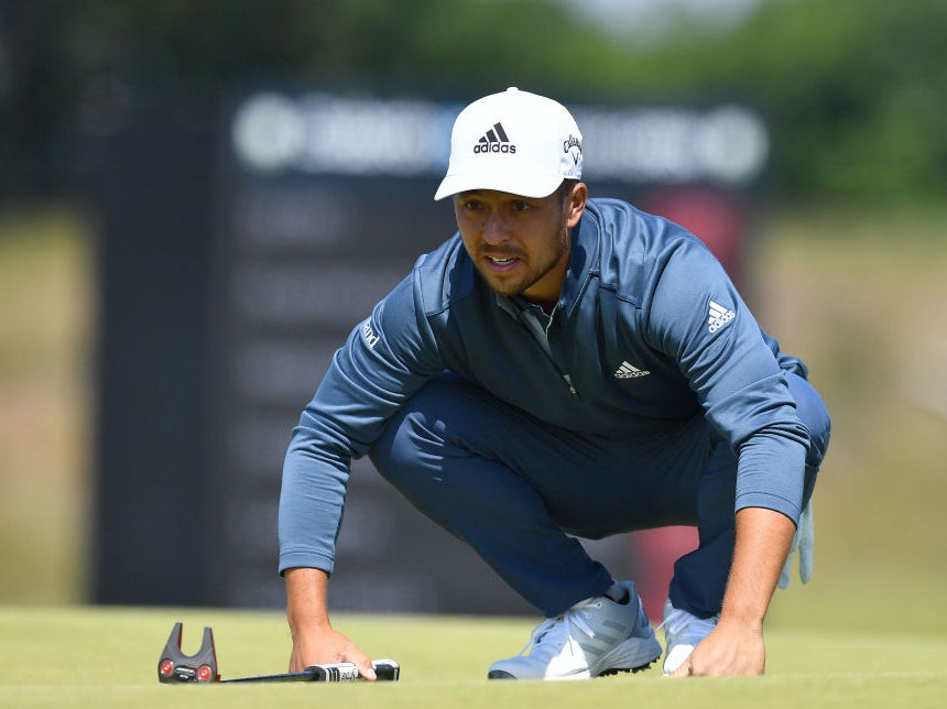 Xander Schauffele lines up a putt at the Scottish Open