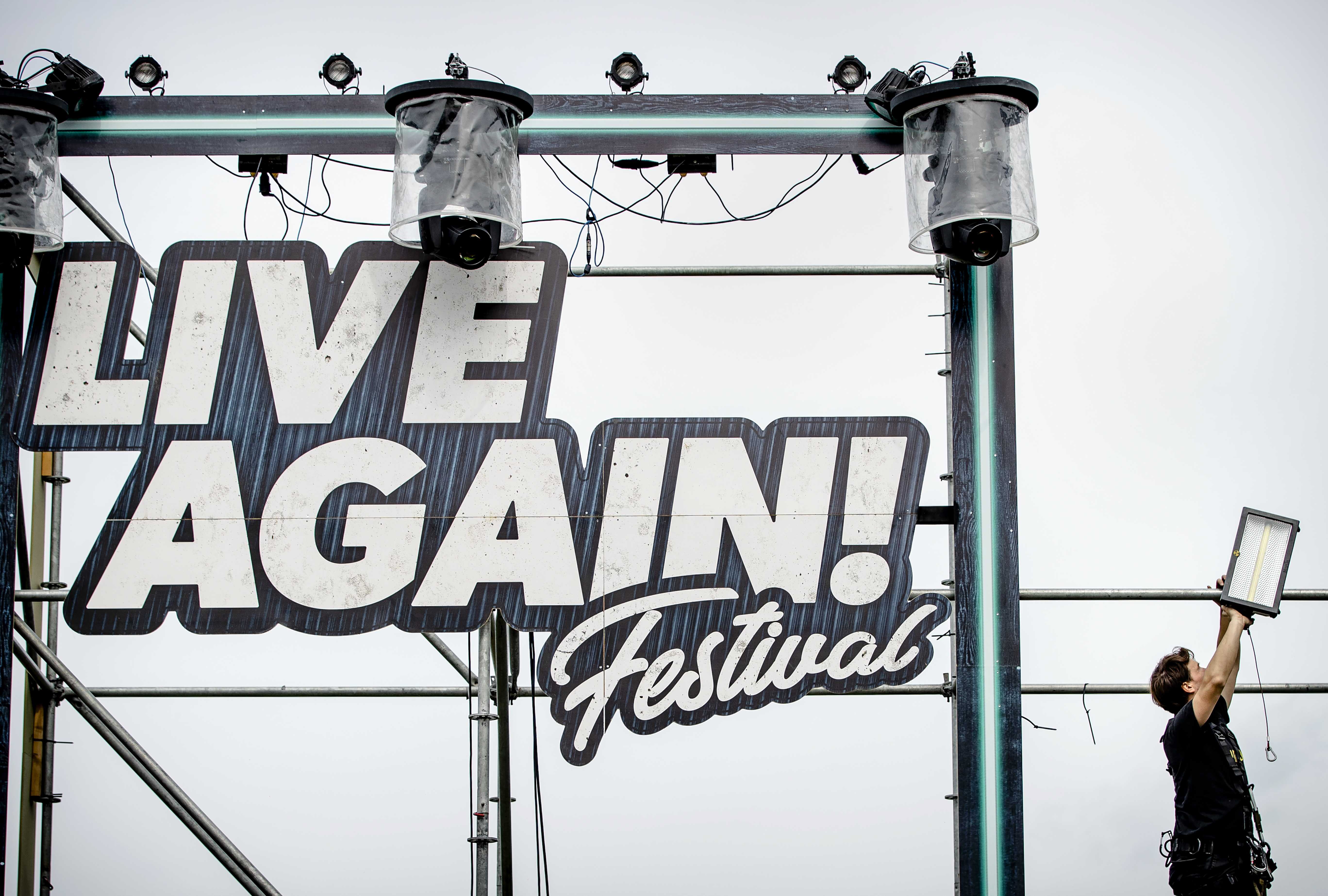 Workers dismantle a stage after the festival 7th Sunday: Live Again! was canceled on short notice in Erp, The Netherlands