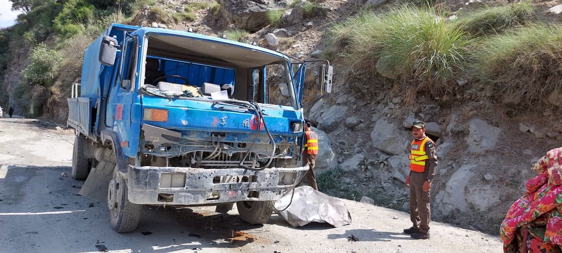 A handout photo by the Rescue 1122 shows Pakistani rescue officials inspect the scene of a blast that hit a bus in Pakistan on 14 July, 2021