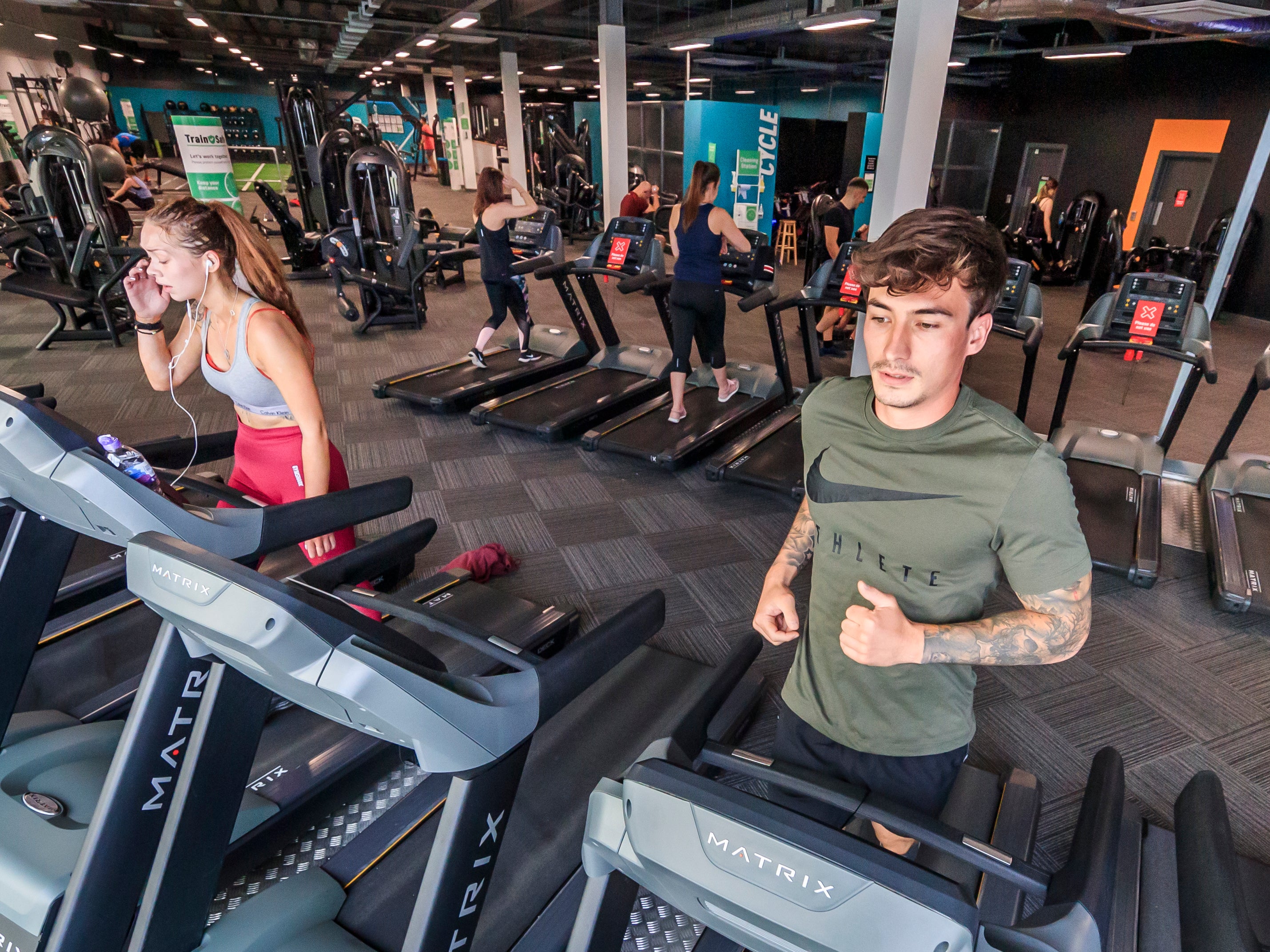 People using exercise machines at a PureGym site