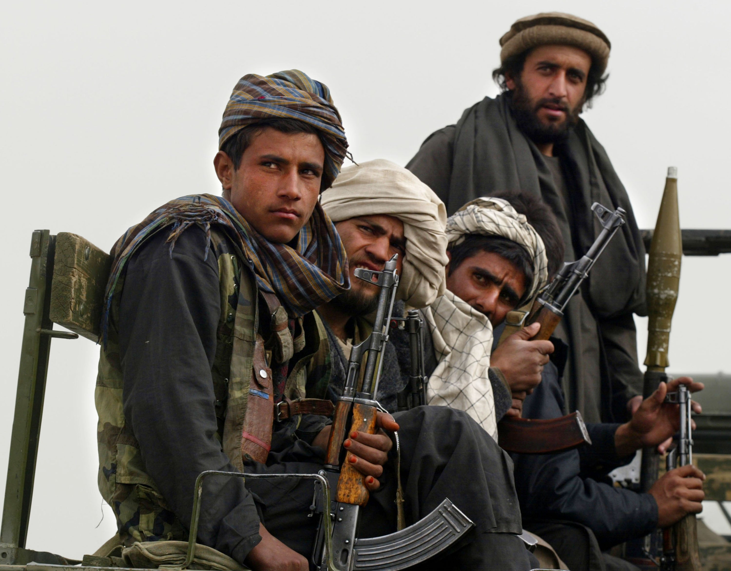 Former Northern Alliance soldiers ride a vehicle towards the town of Gardez, in Afghanistan, on 8 March 2002