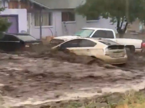 The short clip shows a Toyota Prius being washed downstream amid a torrent of murky water