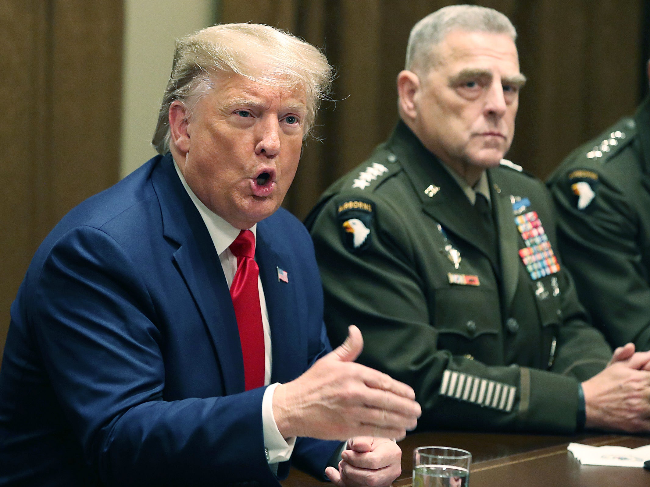 U.S. President Donald Trump speaks as Joint Chiefs of Staff Chairman, Army General Mark Milley looks on after a briefing from senior military leaders in the Cabinet Room at the White House on 7 October 2019 in Washington DC.