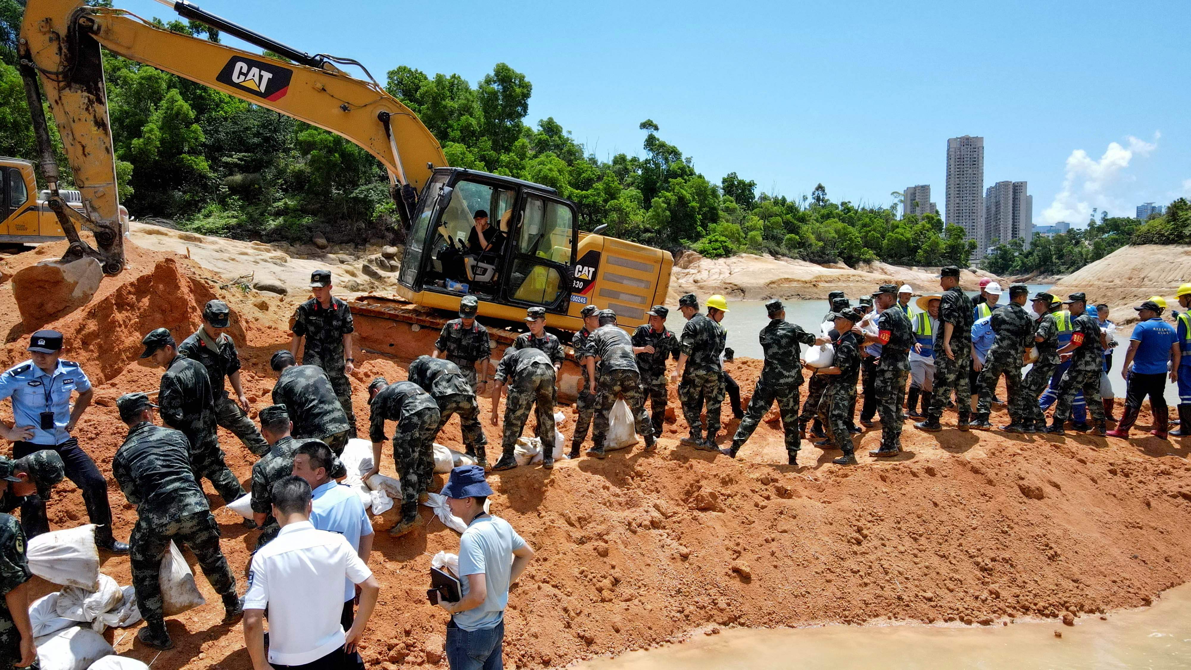 Paramilitary police officers work on trying to rescue 14 workers trapped in Zhuhai, in China's southern Guangdong province