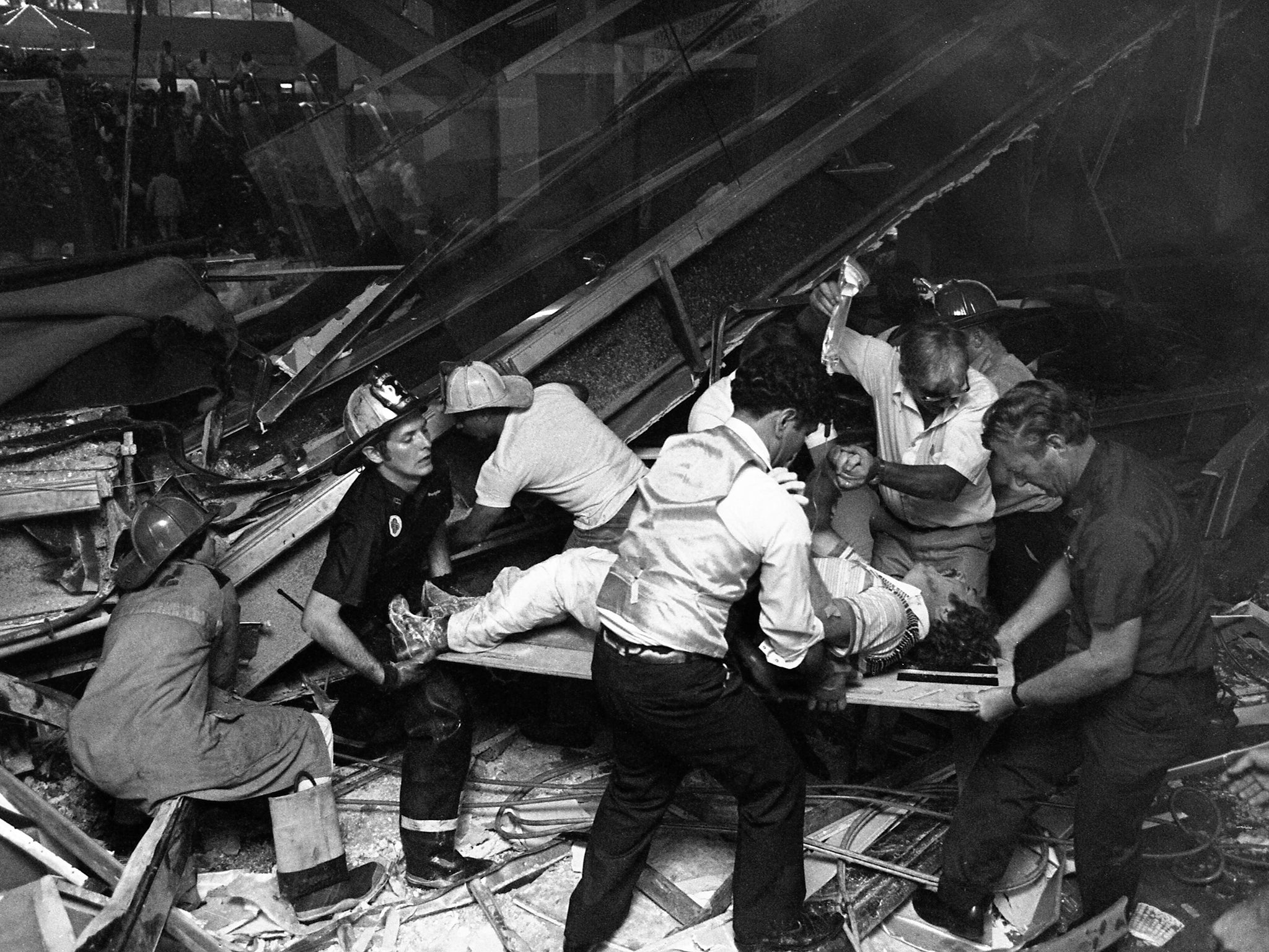 Firefighters rescue people from under a collapsed walkway in the Kansas City Hyatt Regency hotel in 1981