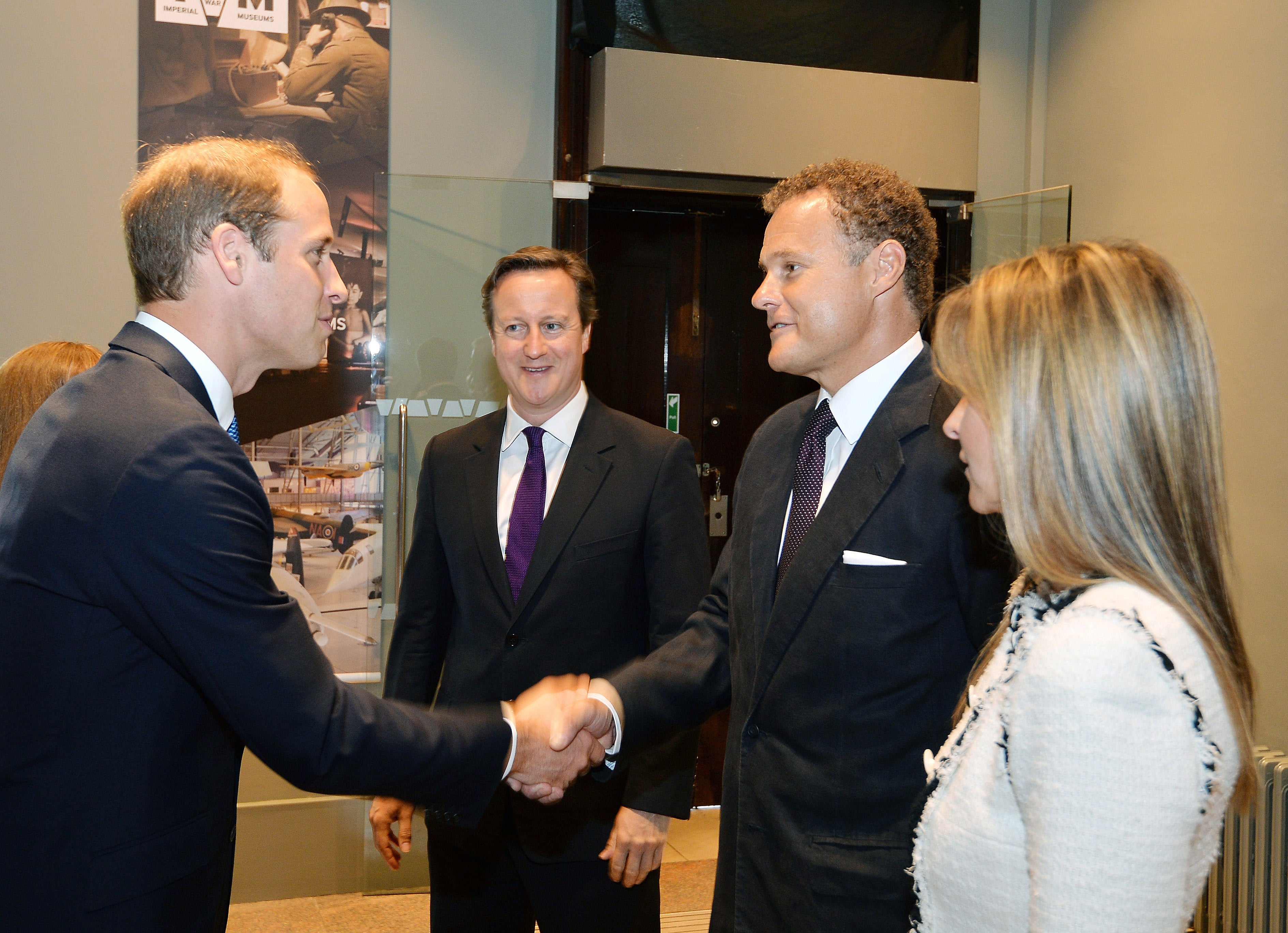 Lord and Lady Rothermere greet Prince William as the then prime minister David Cameron looks on, in July 2014