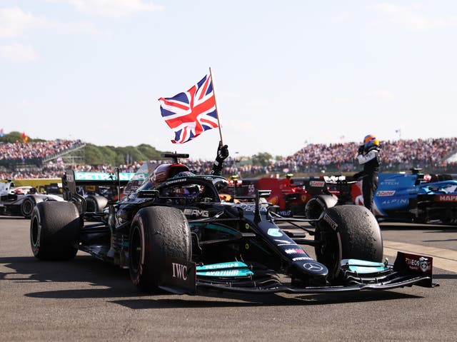 <p>Lewis Hamilton celebrates winning his home grand prix at Silverstone</p>