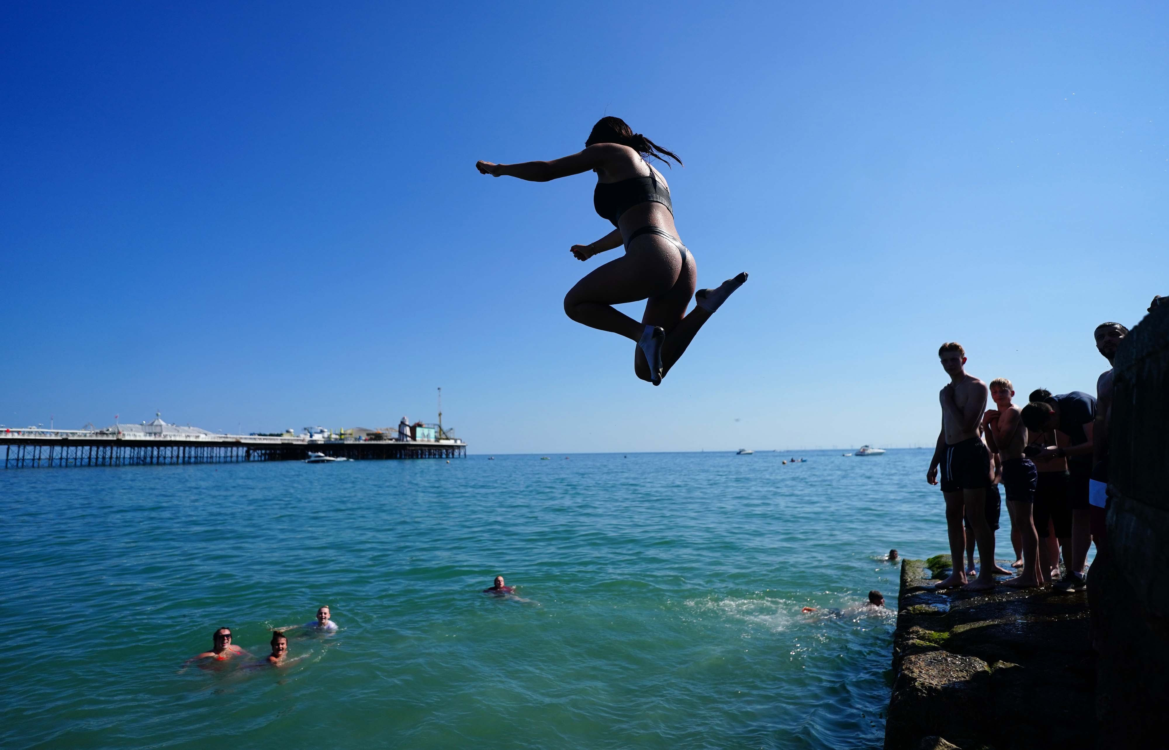 People cool off in the sea at Brighton beach on the hottest day of 2021 so far
