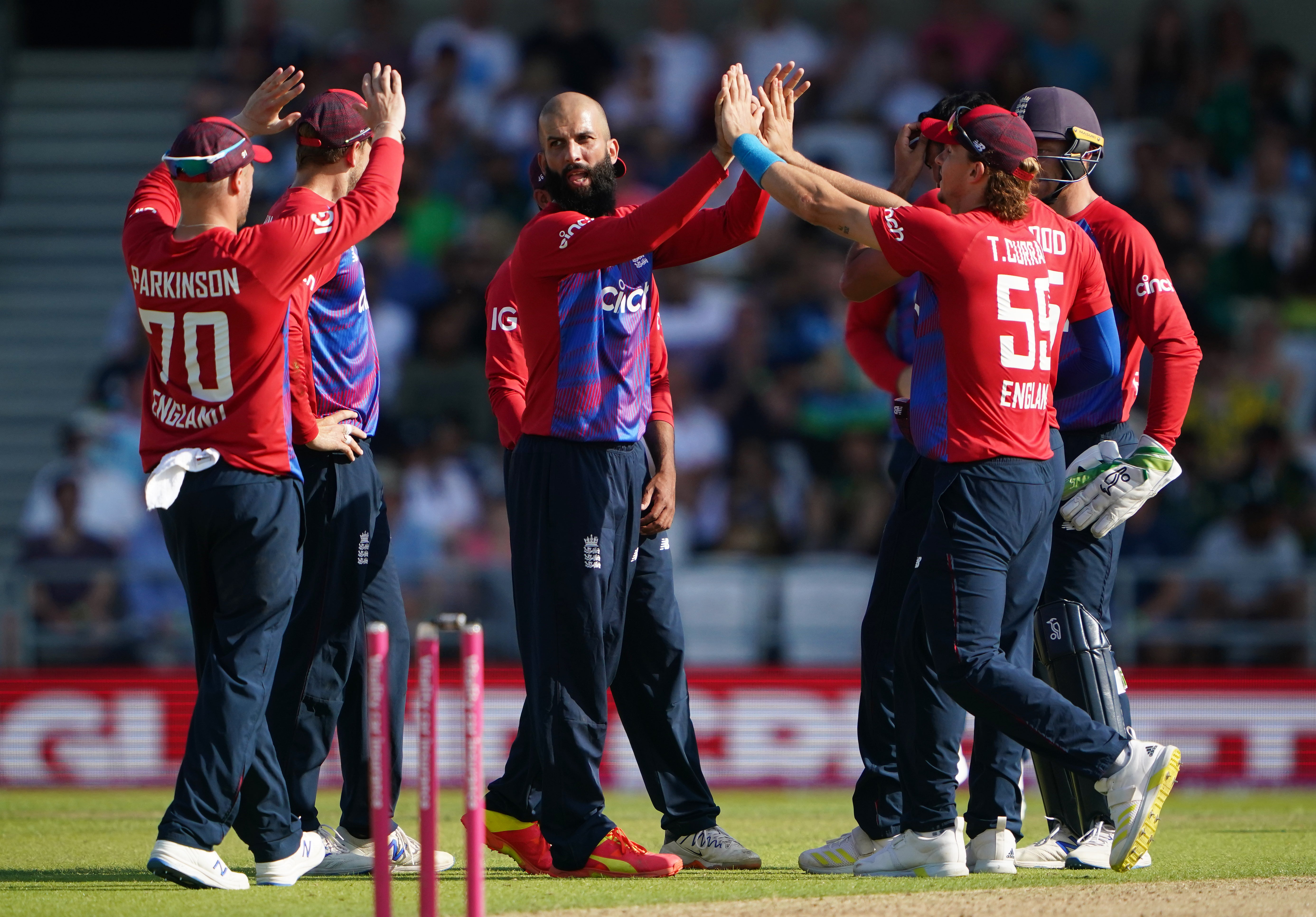 Moeen Ali (centre) celebrates taking the wicket of Fakhar Zaman