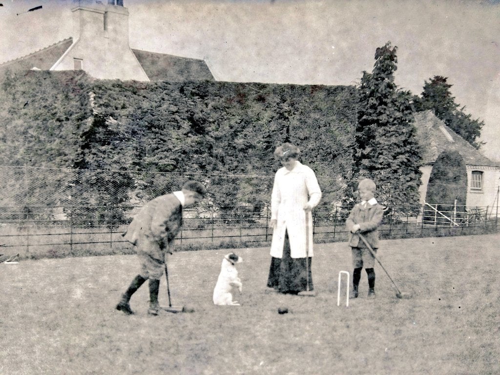 The family has fun with the pet Jack Russell on the croquet lawn